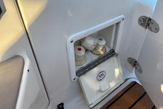 2002 Regal Commodore 2765 boat shower controls with hot and cold water knobs.