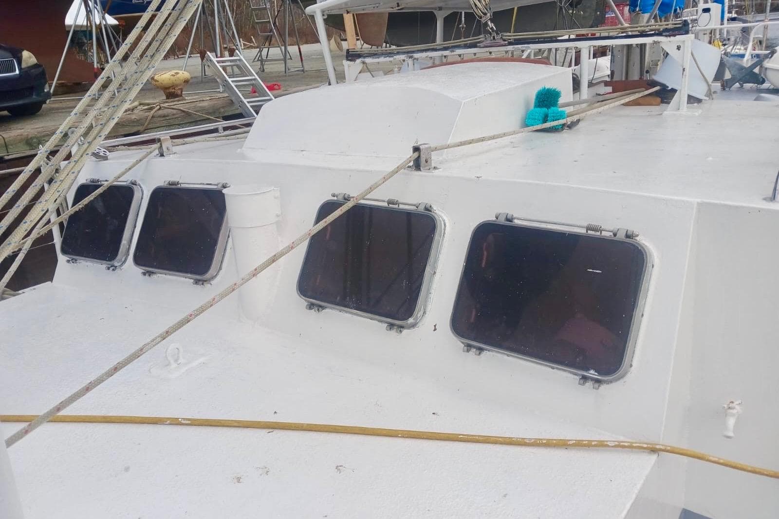 1997 Hike Metal Products 67-foot steel ketch with multiple windows and deck ropes.