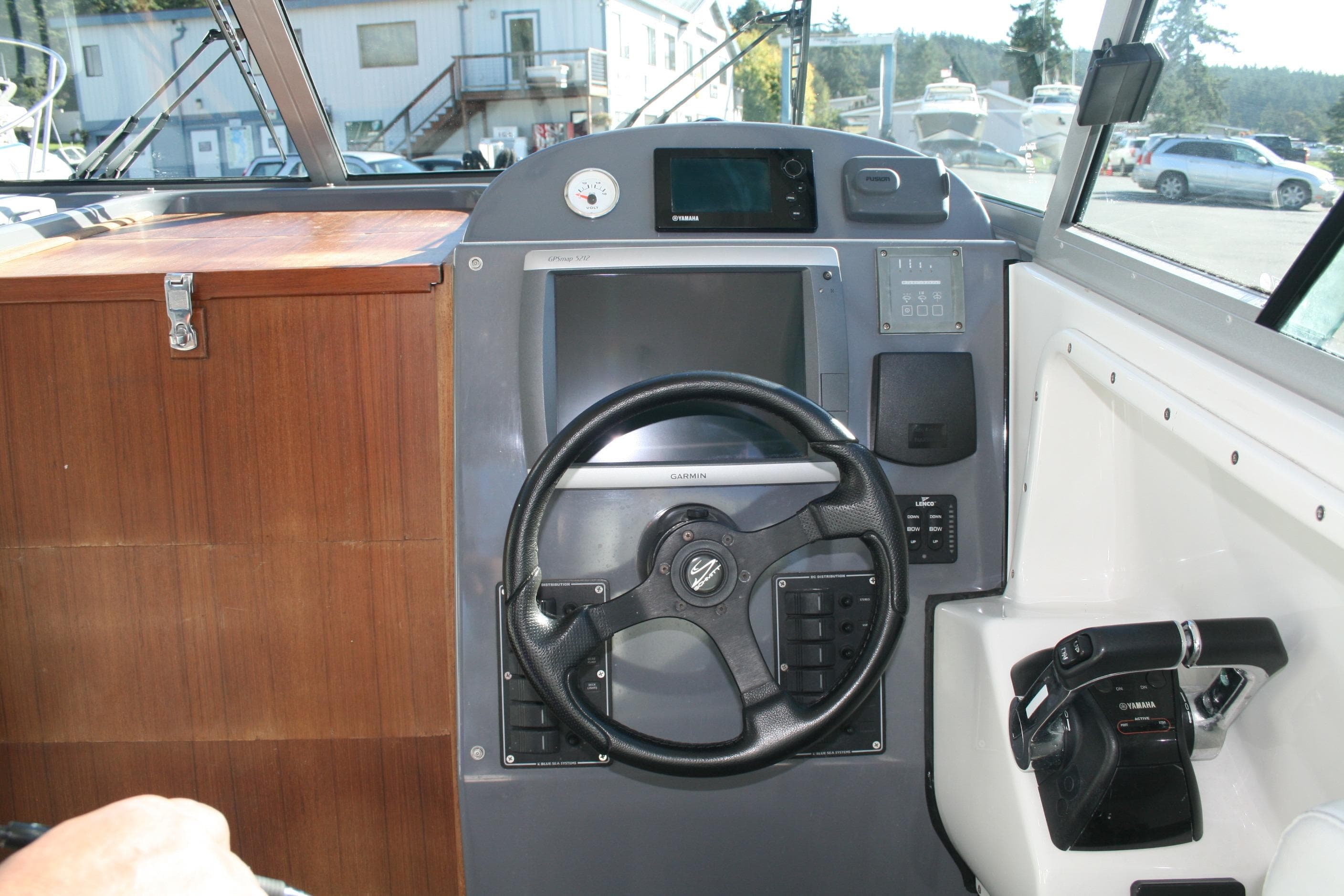 2012 Protector Targa 30 boat helm with steering wheel and navigation controls.