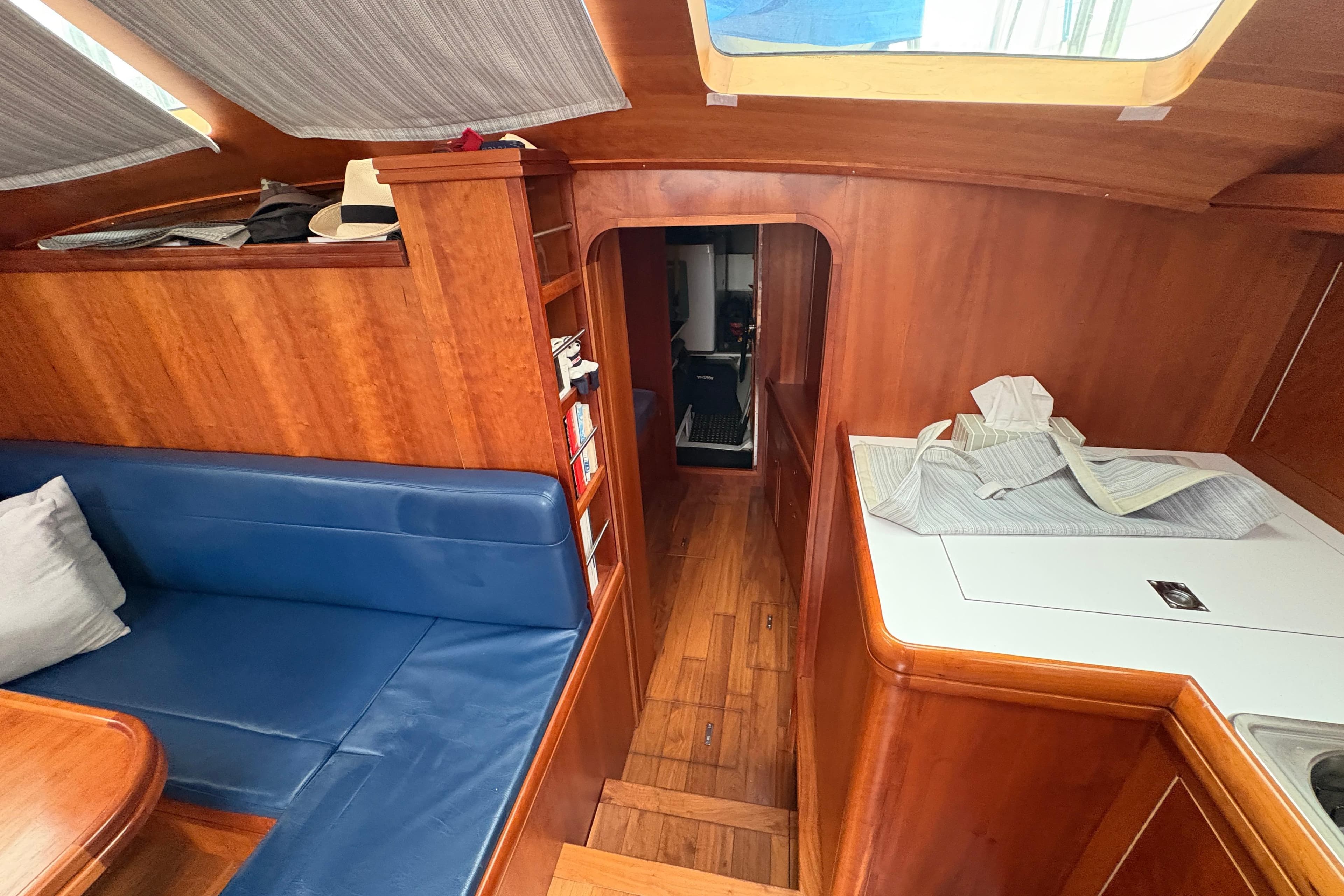 Interior of 2019 Chatam Extreme 42 yacht with wooden finish and blue seating.