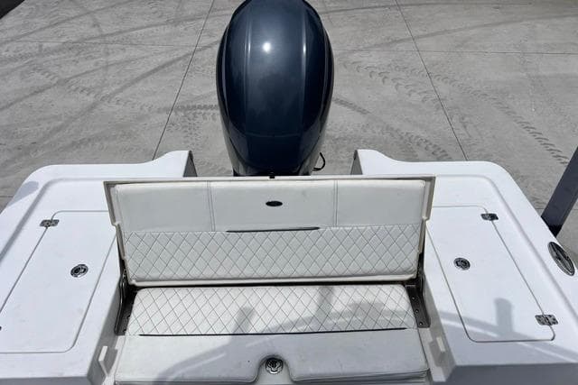 2021 Sportsman Tournament 234 SBX Bay Boat with open storage compartment and outboard motor.