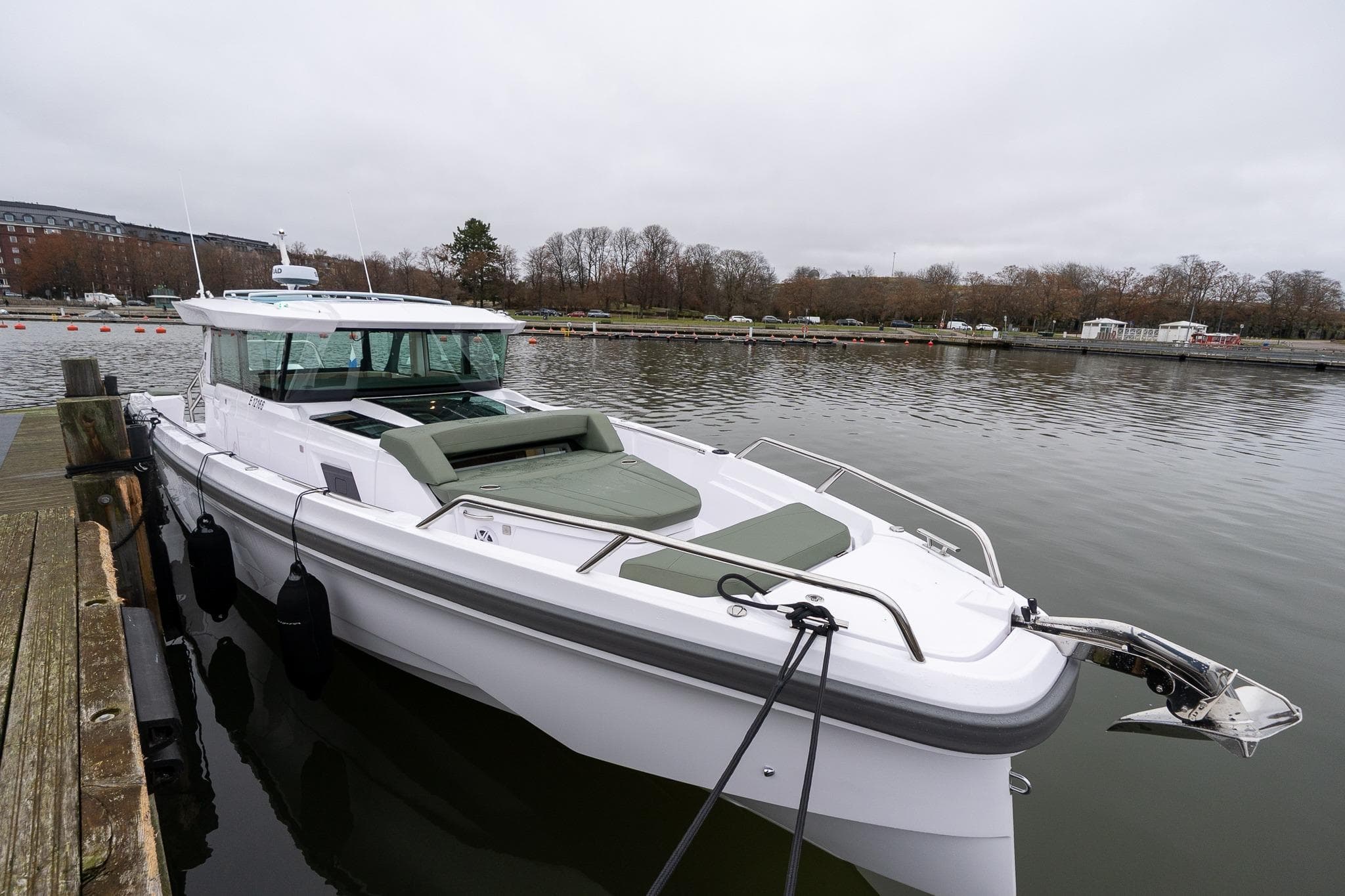 2027 Axopar 38 Cross Cabin boat docked on a calm river.