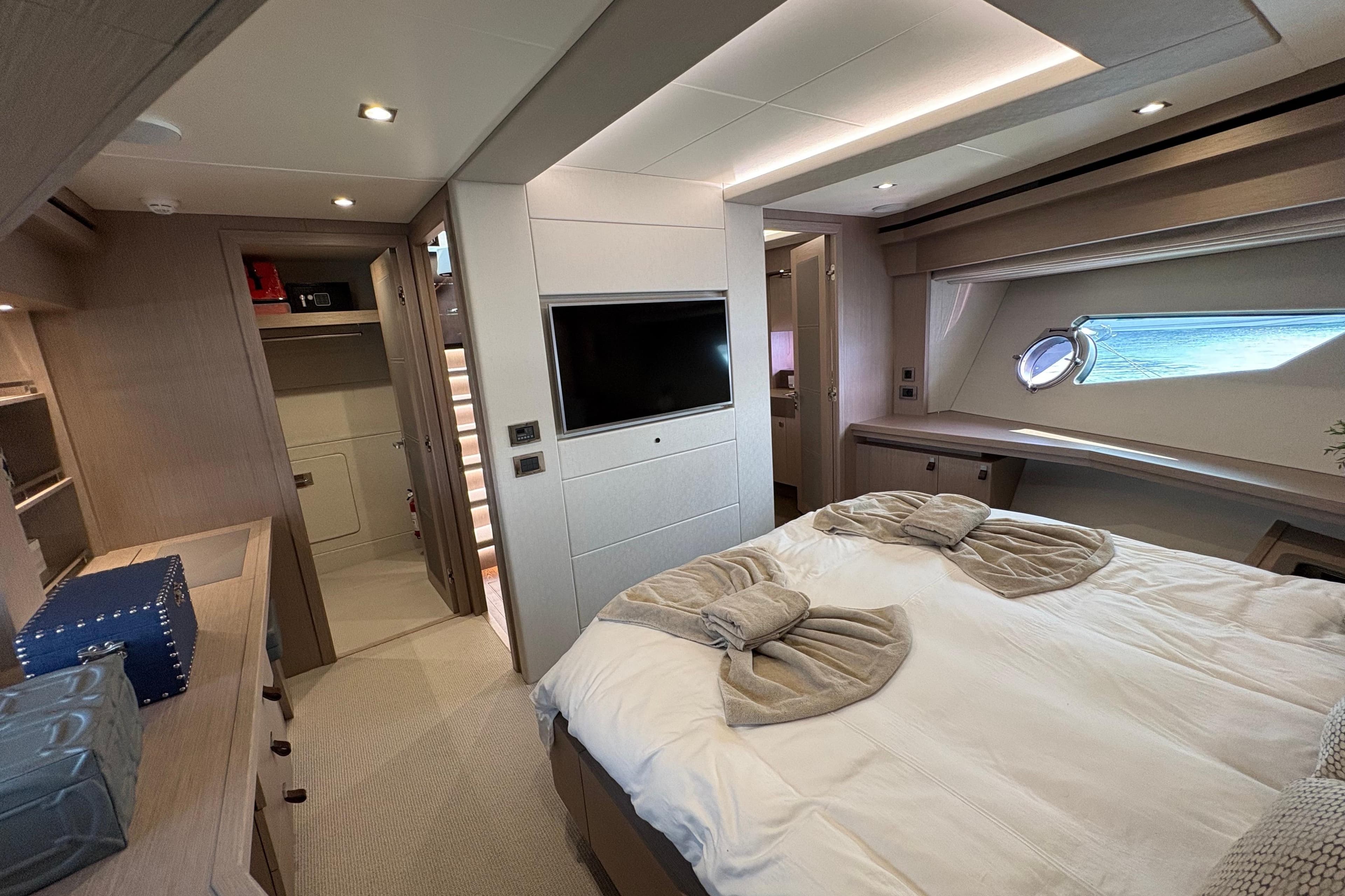 Luxurious bedroom interior of 2018 Sunseeker 86 Yacht with modern amenities and elegant design.