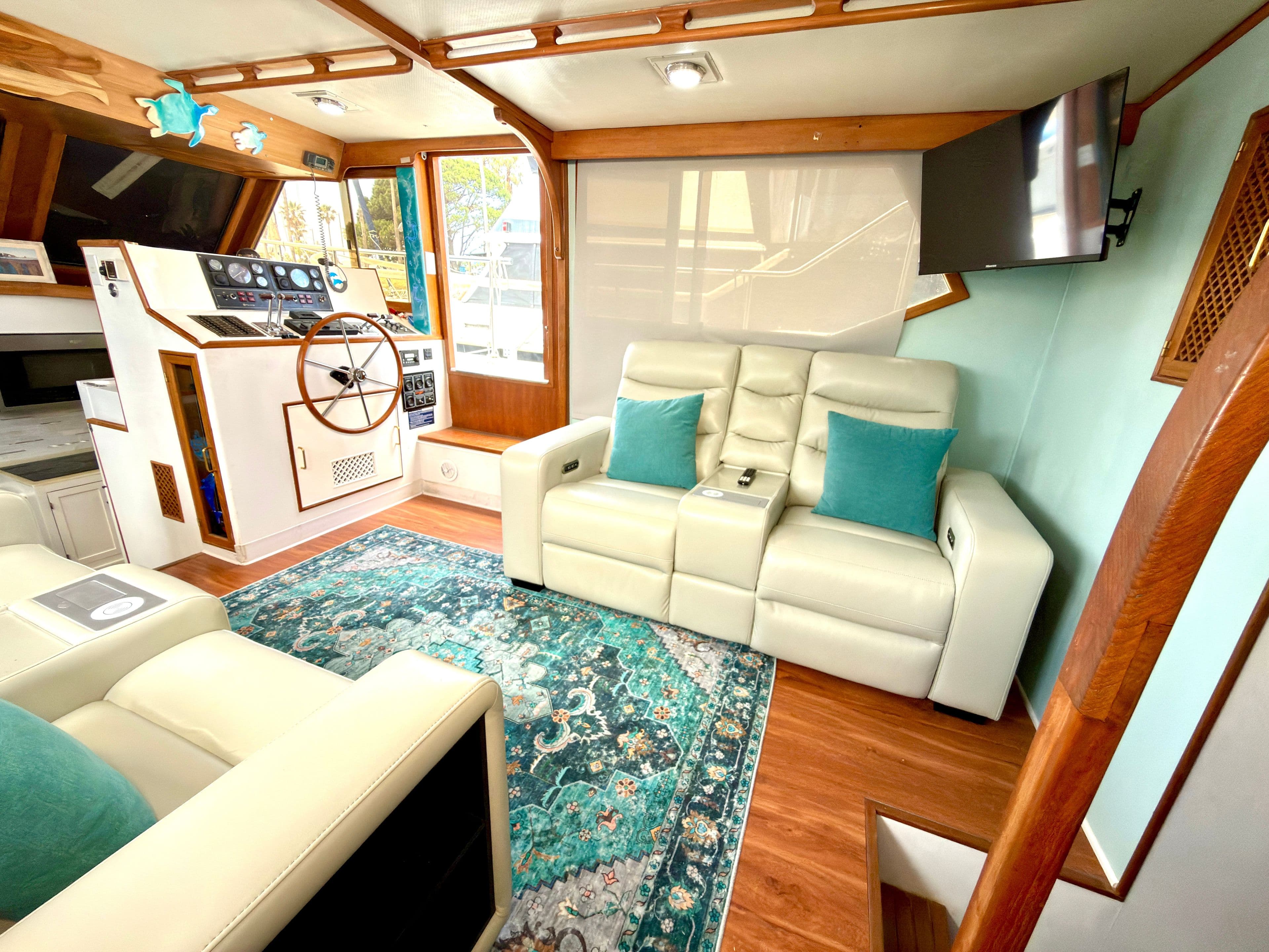 Interior of 1987 CHB 46 Cockpit Motoryacht with leather sofas and steering wheel.
