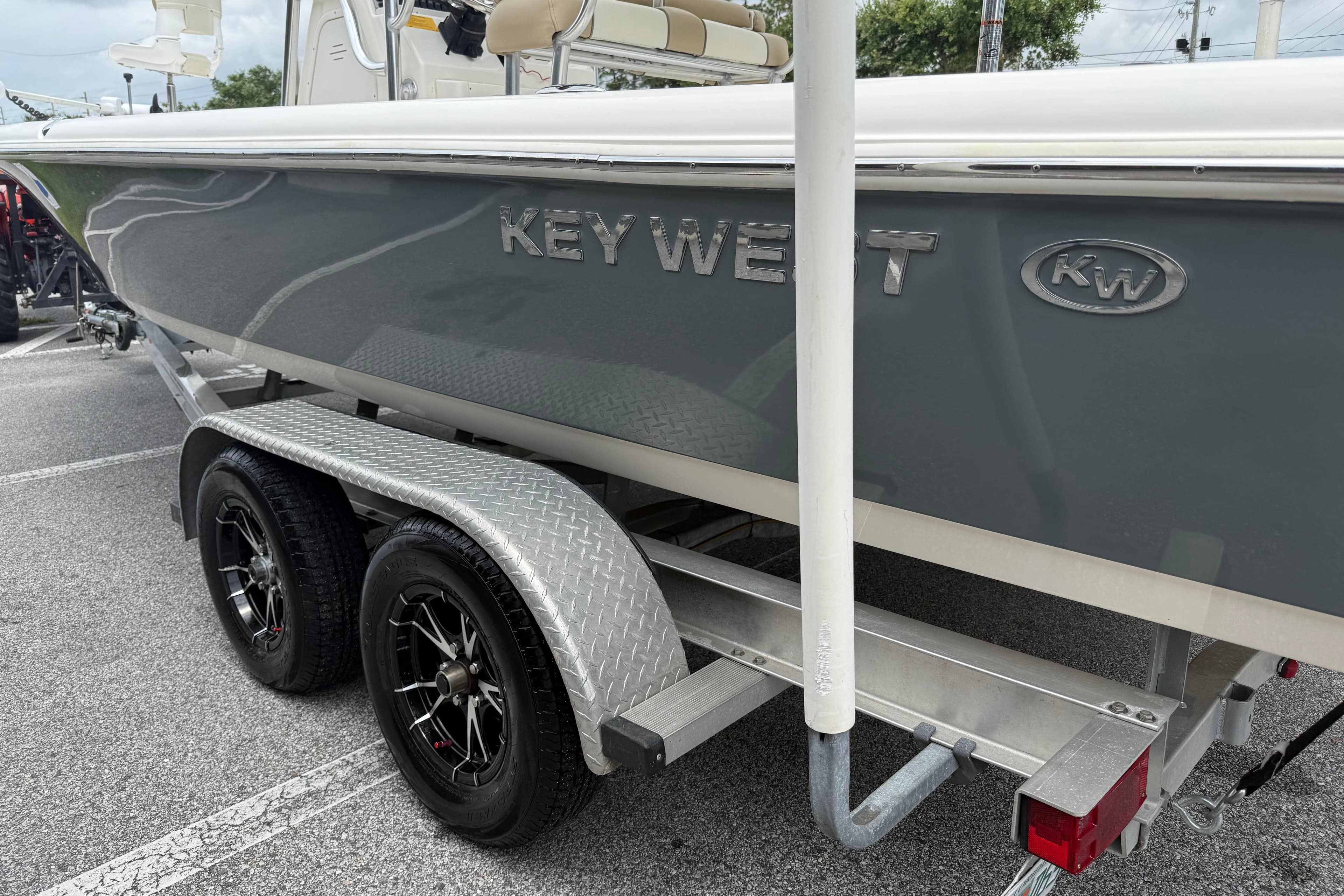 2017 Key West 246 Bay Reef boat on a dual-axle trailer in a parking lot.