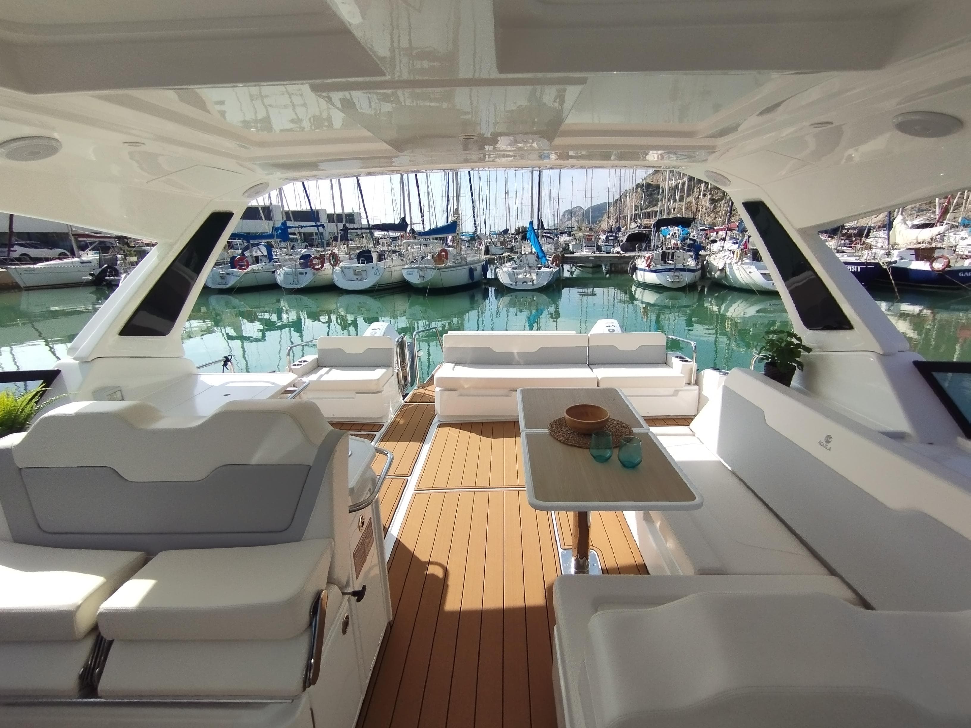 Luxurious 2024 Aquila 36 Sport yacht interior with marina view.
