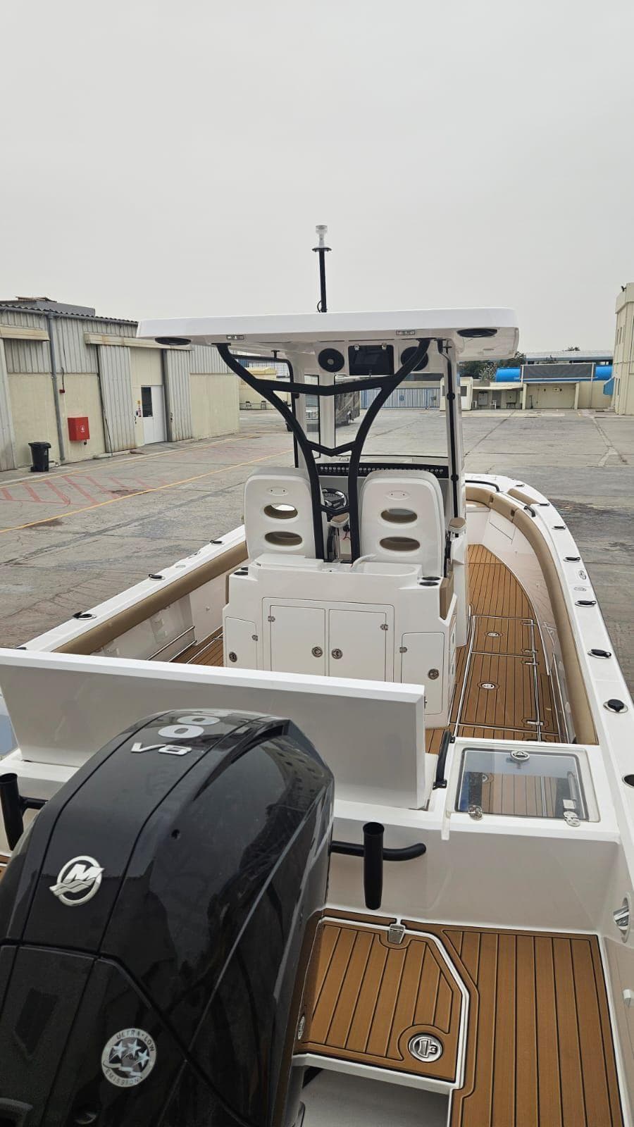 2024 Center Console ARROW 320 boat with sleek design and powerful engine, docked outdoors.