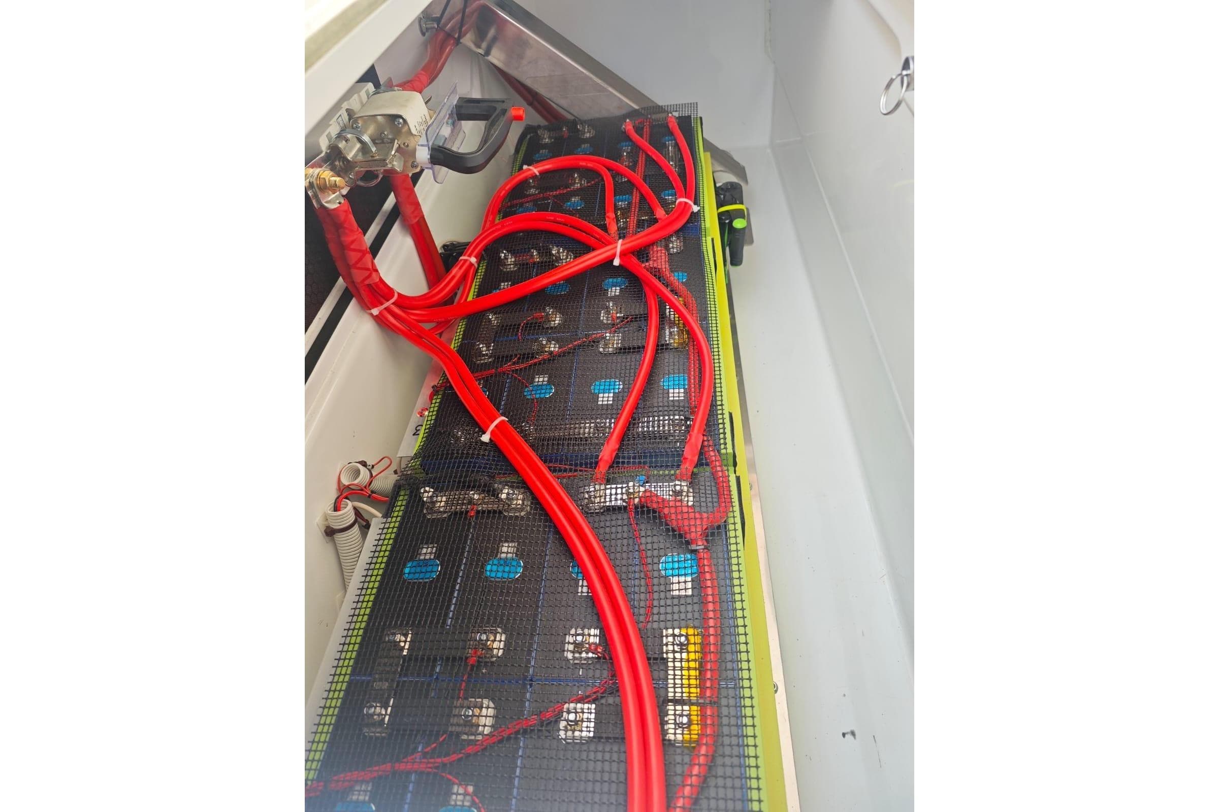 2024 Fountaine Pajot Astrea 42 Catamaran battery compartment with red cables and connections.