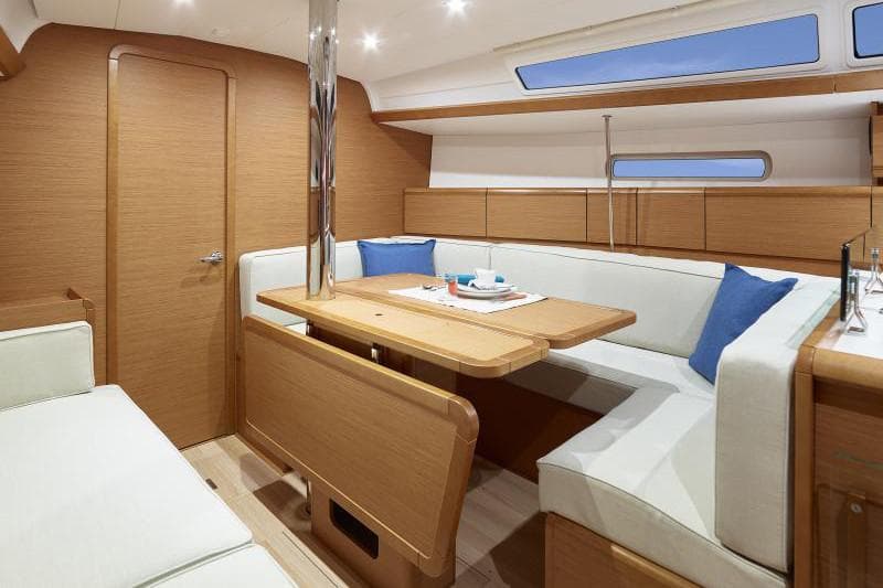 Manufacturer Provided Image: Interior of 2019 Jeanneau Sun Odyssey 389 sailboat with modern wood finish and cozy seating.
