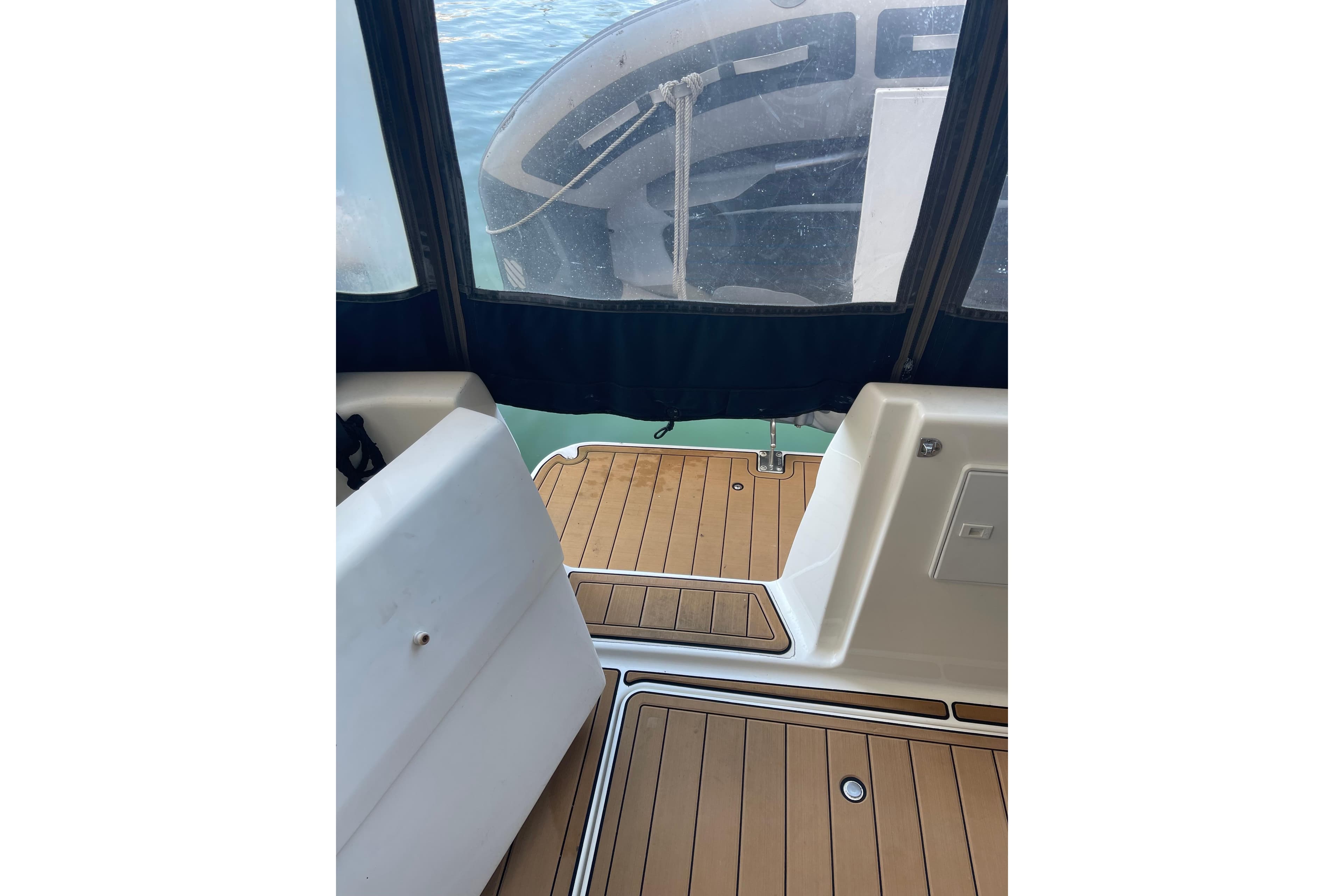 2001 Bayliner 3388 Command Bridge Motoryacht interior with teak flooring and view of water.