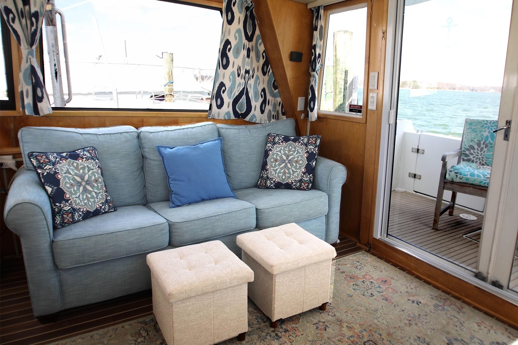 Cozy interior of 1996 Navigator Classic 50 yacht with blue sofa and nautical decor.
