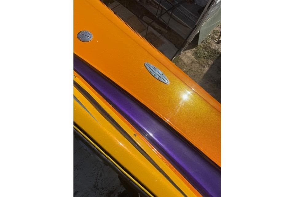 2008 Nor-Tech 3600 Supercat with vibrant orange and purple detailing.