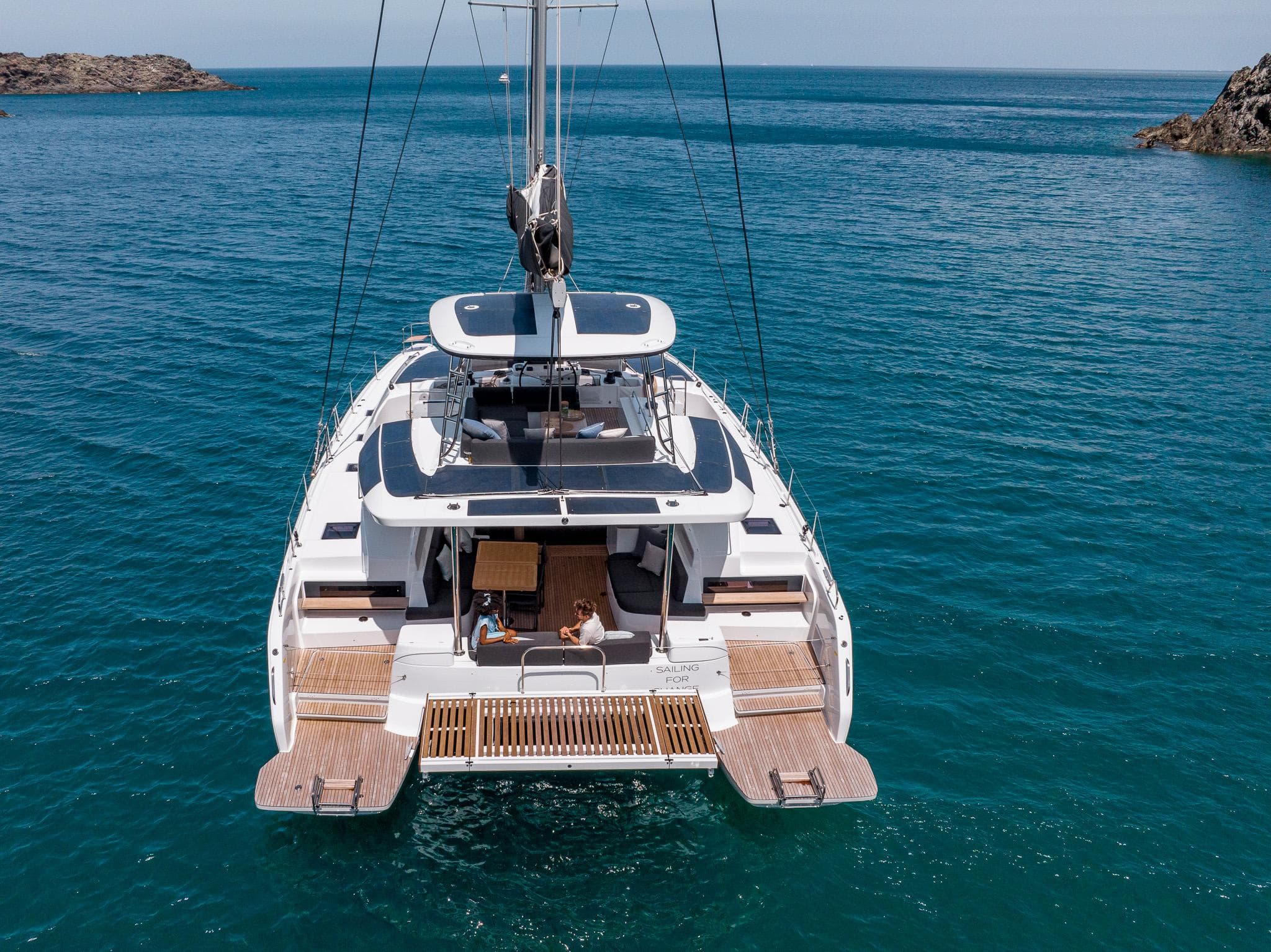 2025 Lagoon 51 ICONIC yacht on serene blue waters, showcasing luxury and elegance.