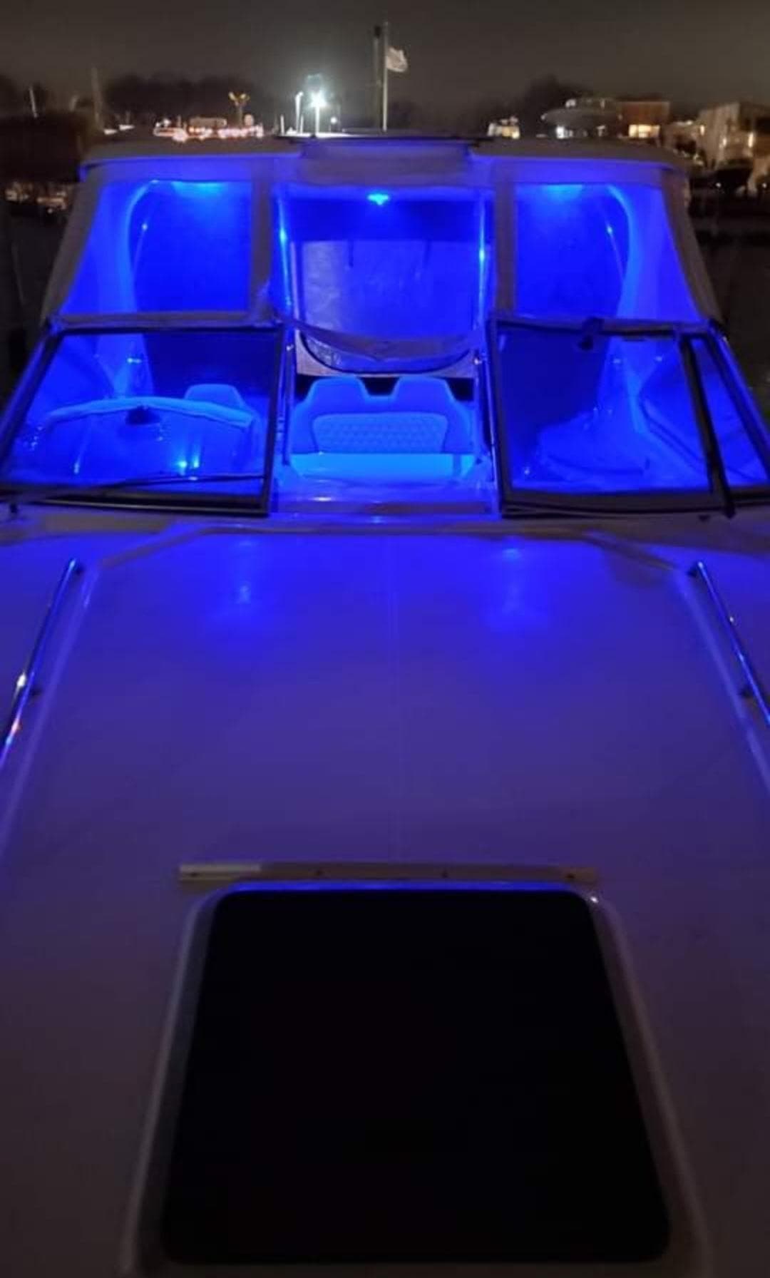 2014 Chaparral 330 Signature Cruiser with blue interior lighting at night.