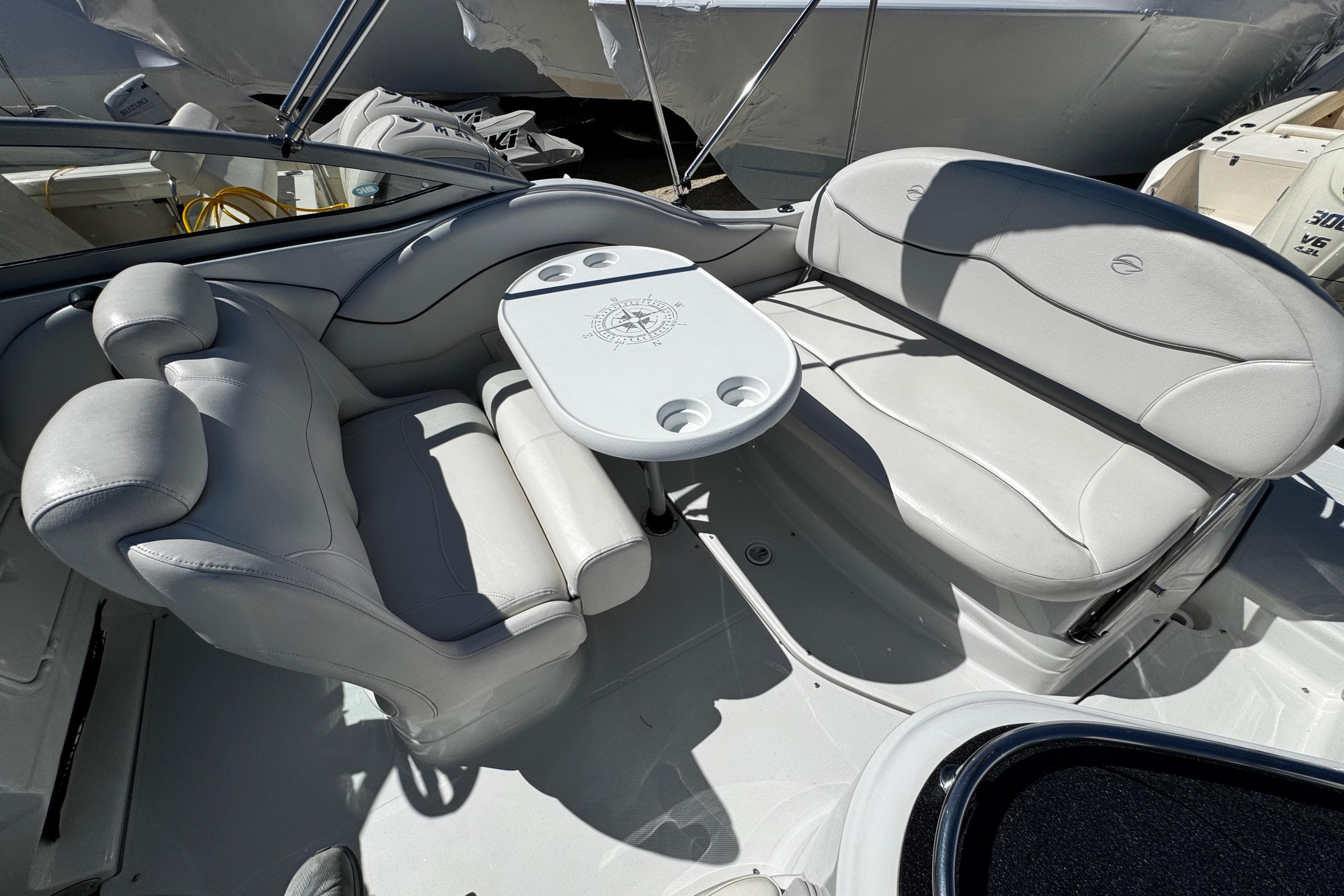 2004 Crownline 250 CR boat interior with white seating and table.