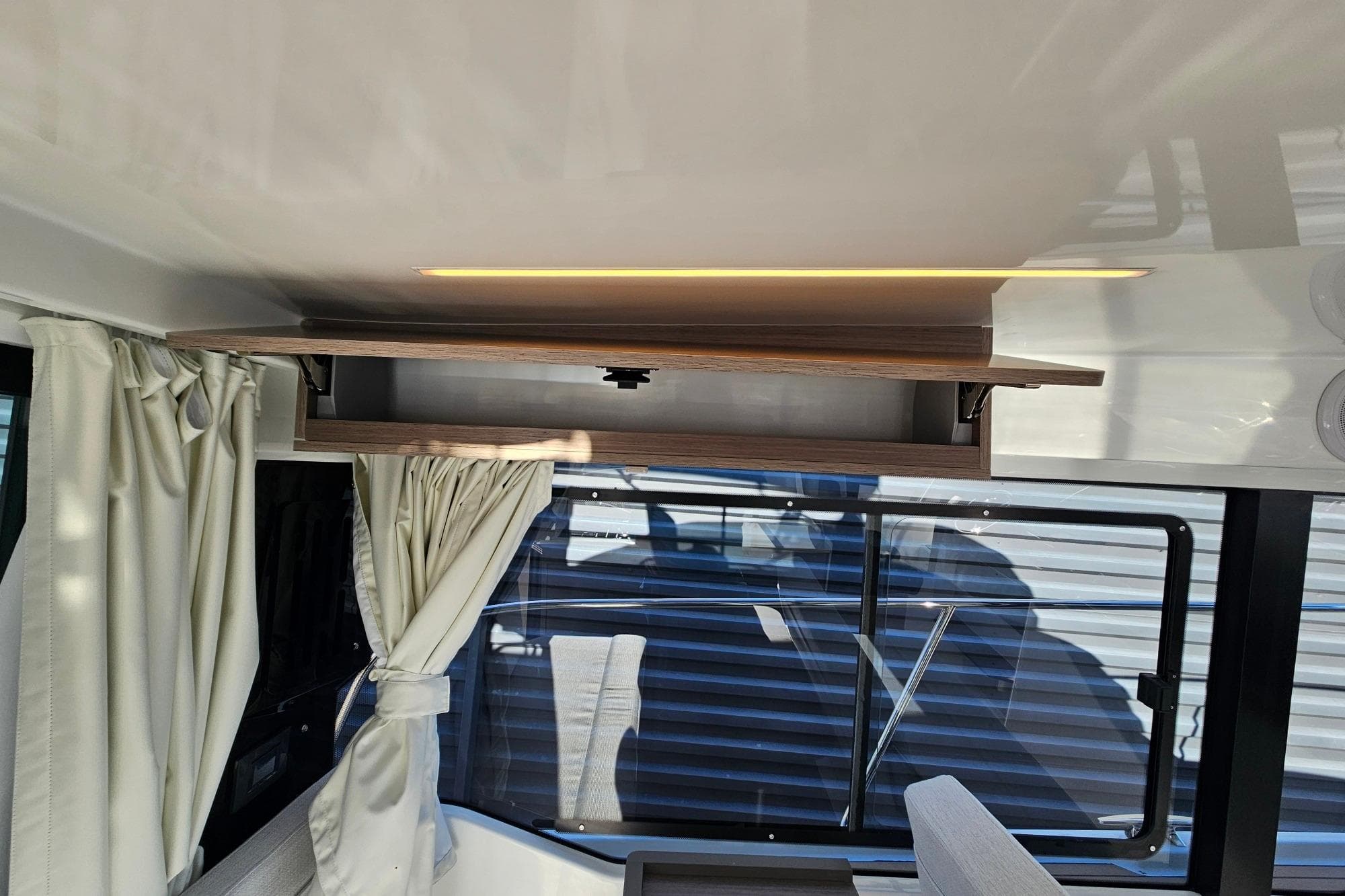 Interior of 2026 Jeanneau Merry Fisher 1095 Fly Serie 2 with modern design and lighting.