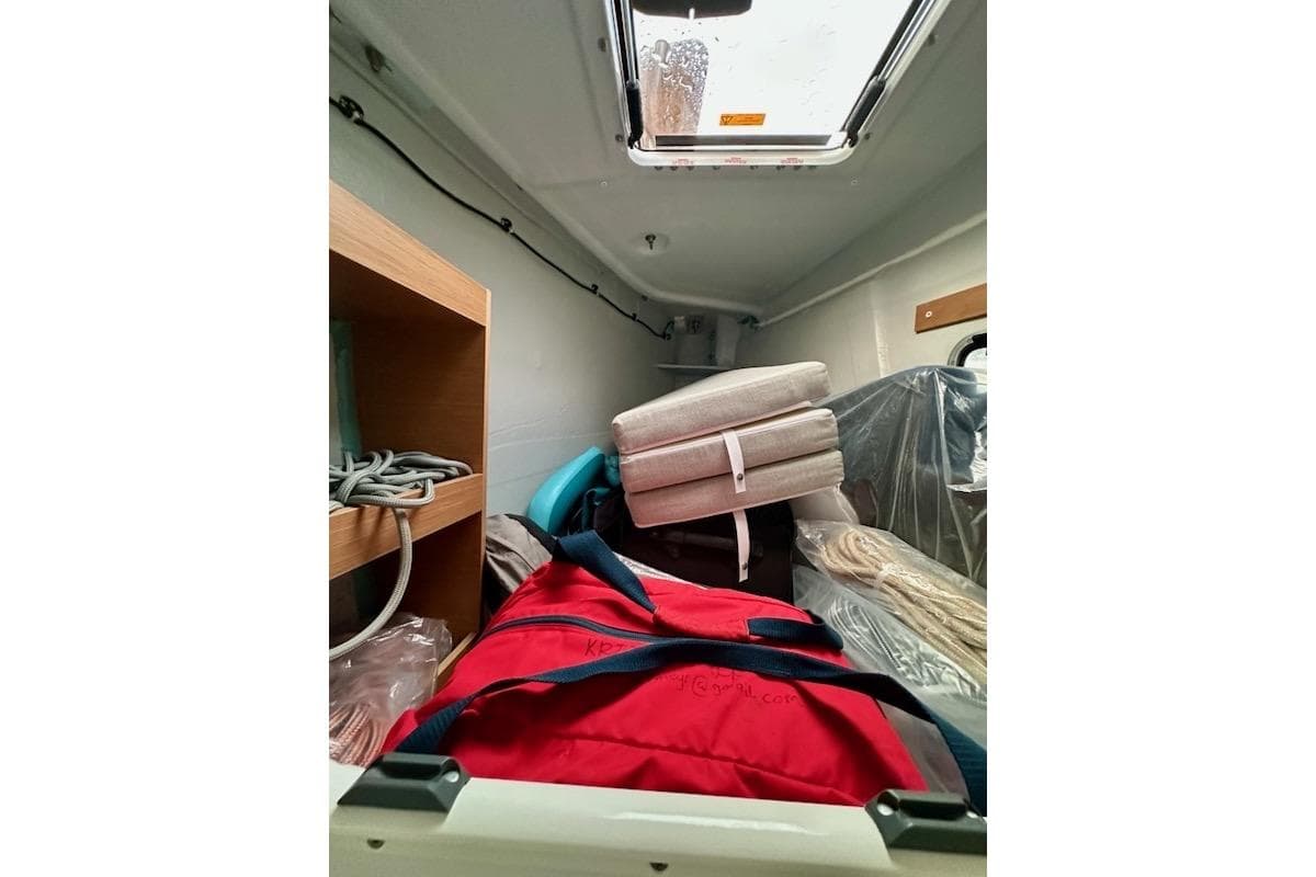 Interior of 2025 Excess 14 boat with storage and cushions.