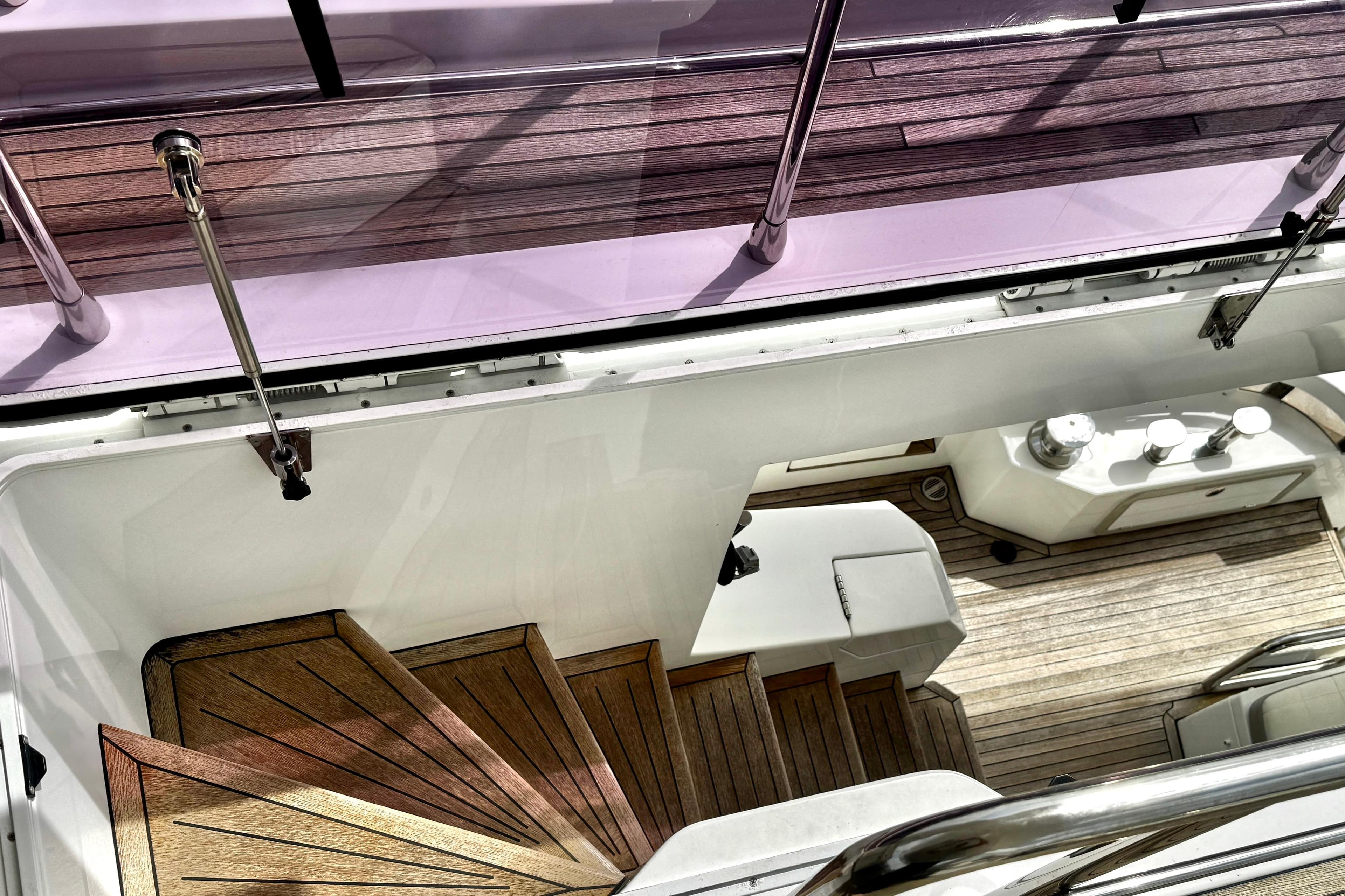 Staircase and deck view of 2019 Azimut Fly 72 yacht with wooden flooring.