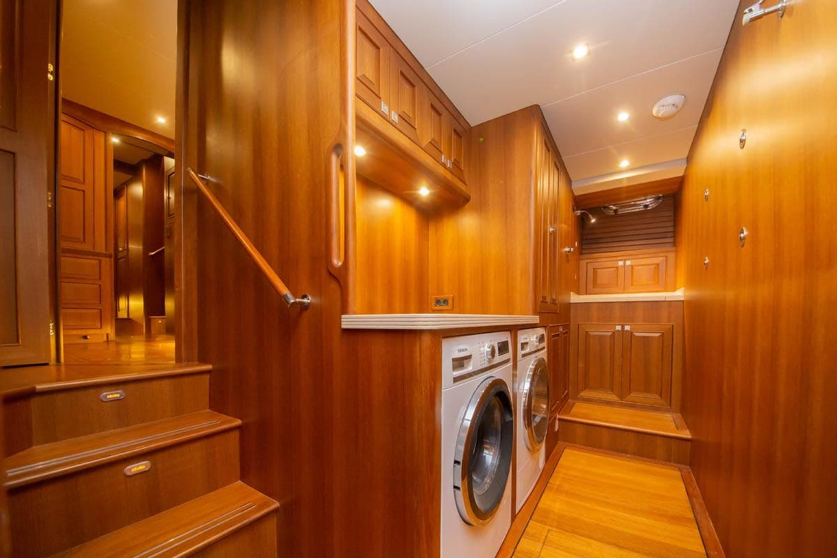 Luxurious wooden interior of 2026 Selene 60 Classic Explorer yacht with laundry appliances.