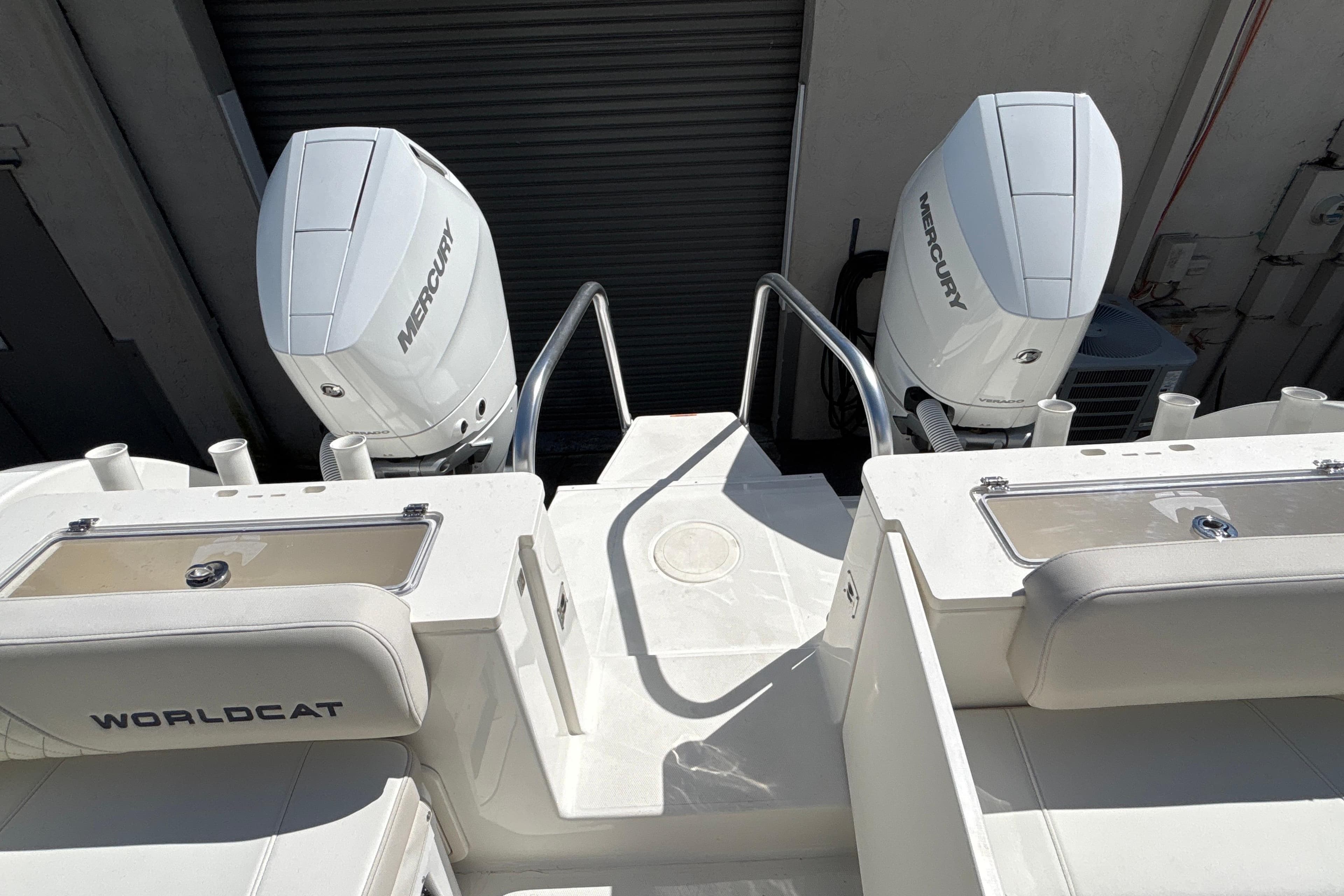 2025 World Cat 325 CC boat with dual Mercury engines, rear view.
