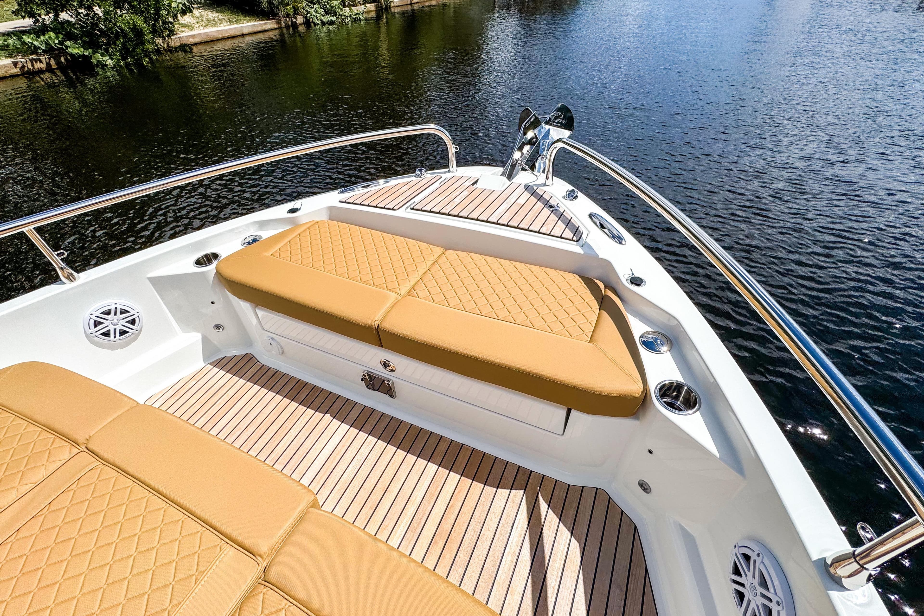 2025 Wellcraft 38 Explorer boat with tan cushioned seating and sleek deck design.