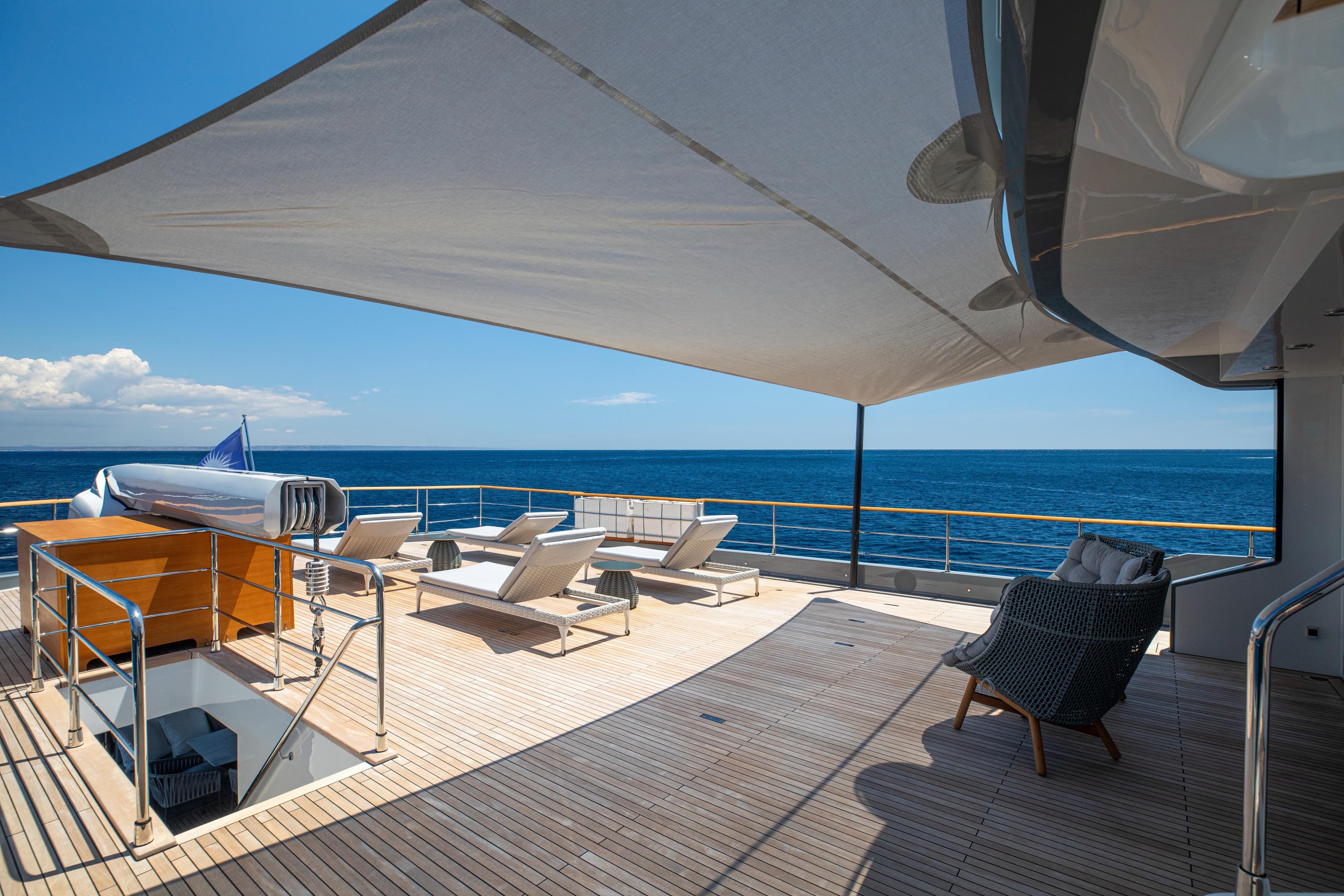 Luxurious deck of 2023 Numarine 37XP yacht with sun loungers and ocean view.