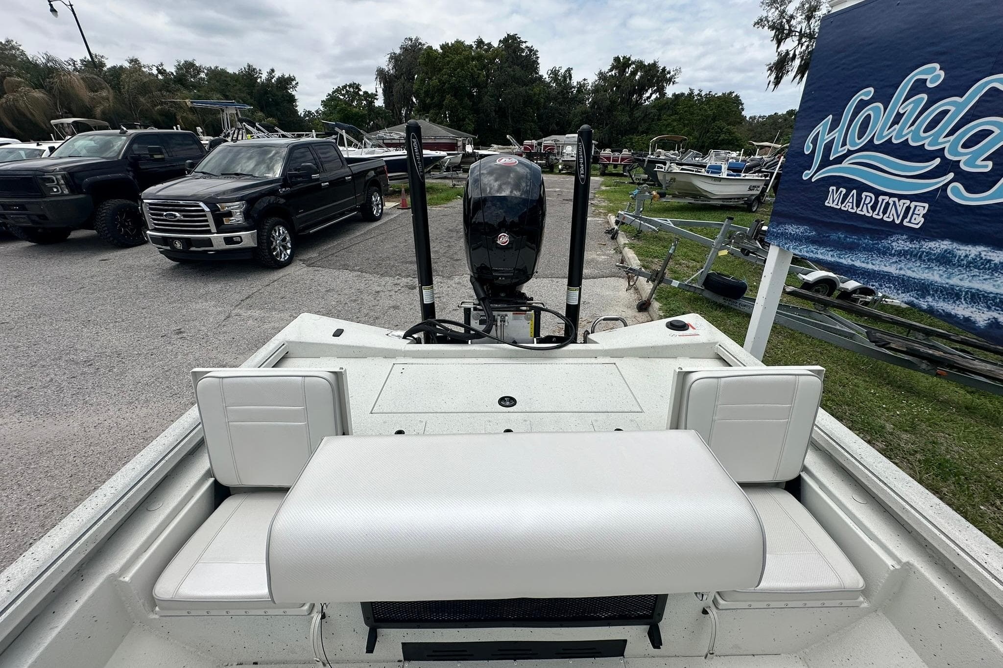 2026 Ranger RB200 boat at Holiday Marine dealership, featuring a spacious seating area and motor.