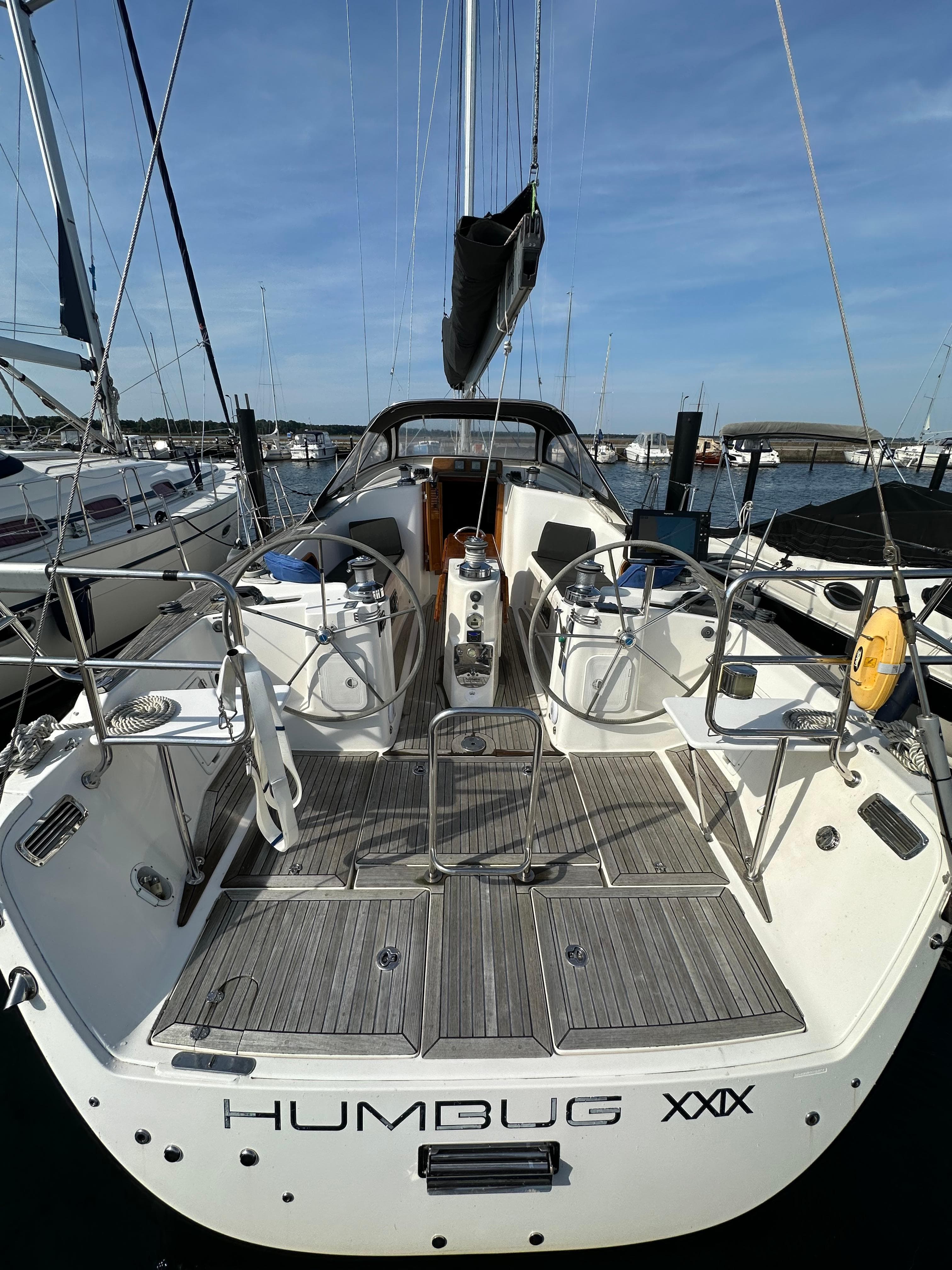 Sailboat Maxi 1300, 2007 model, docked at marina, rear view.