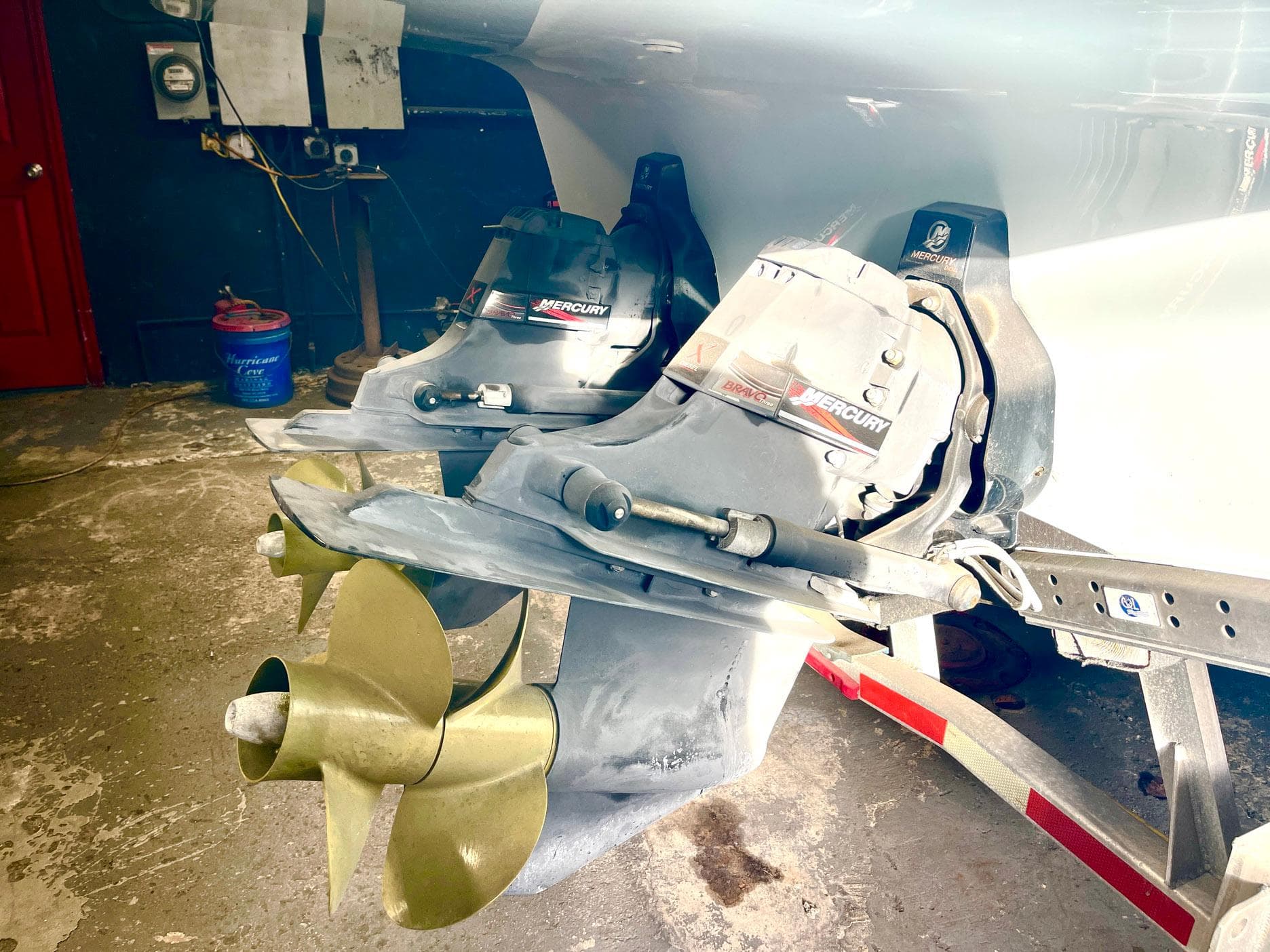 Propellers and Mercury engines of a 2008 Goetz Custom Boats 33' Limo Tender in a workshop.