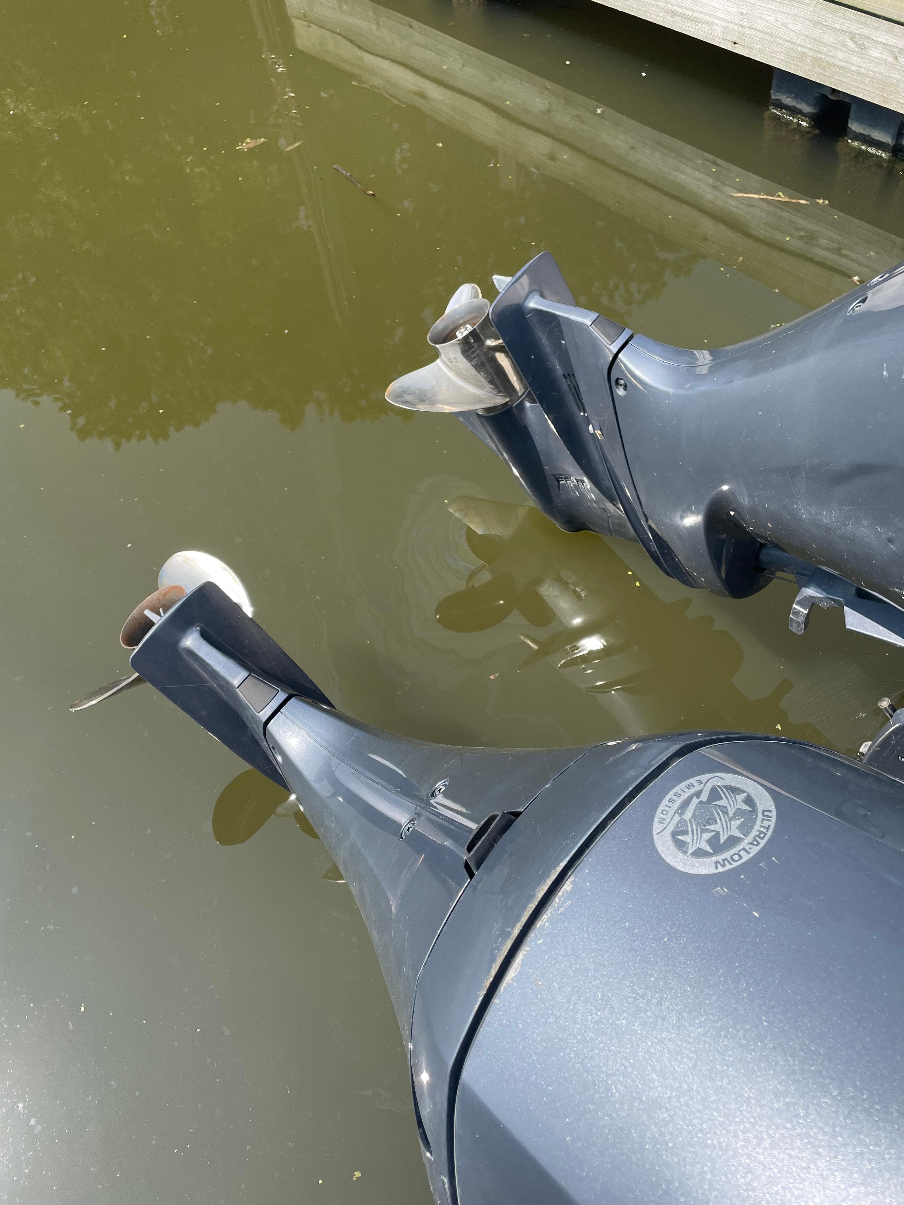 Outboard motors of a 2023 Sailfish 276 DC boat in water.