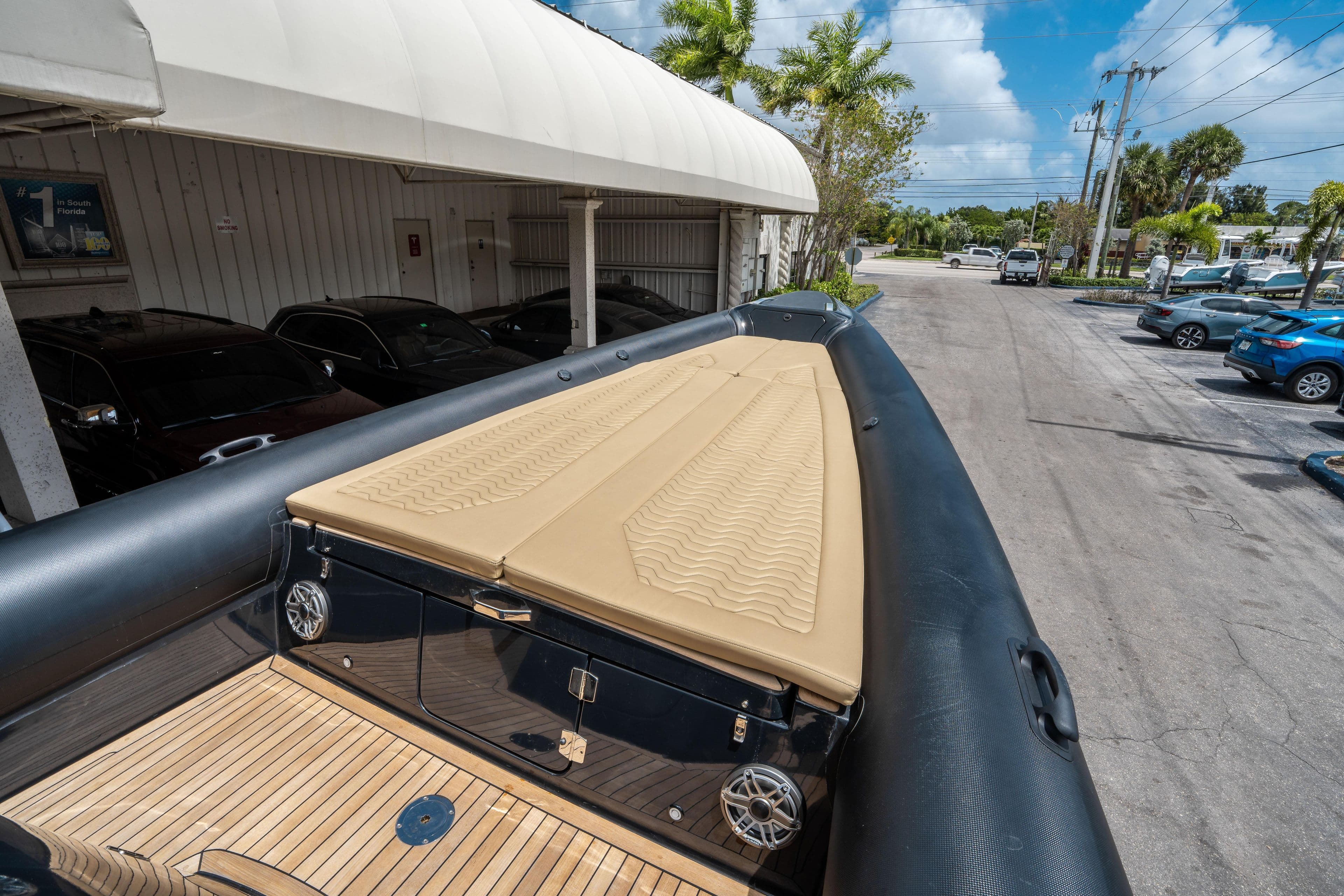2023 Ribco Seafarer 36 X boat with tan deck, parked outdoors.