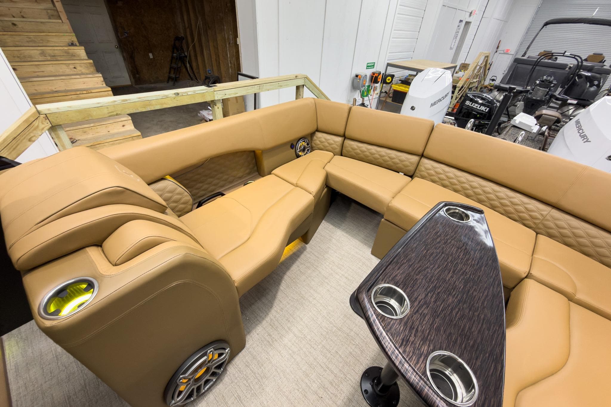 Luxurious interior of 2026 Godfrey Sanpan 27' Tritoon with plush seating and table.