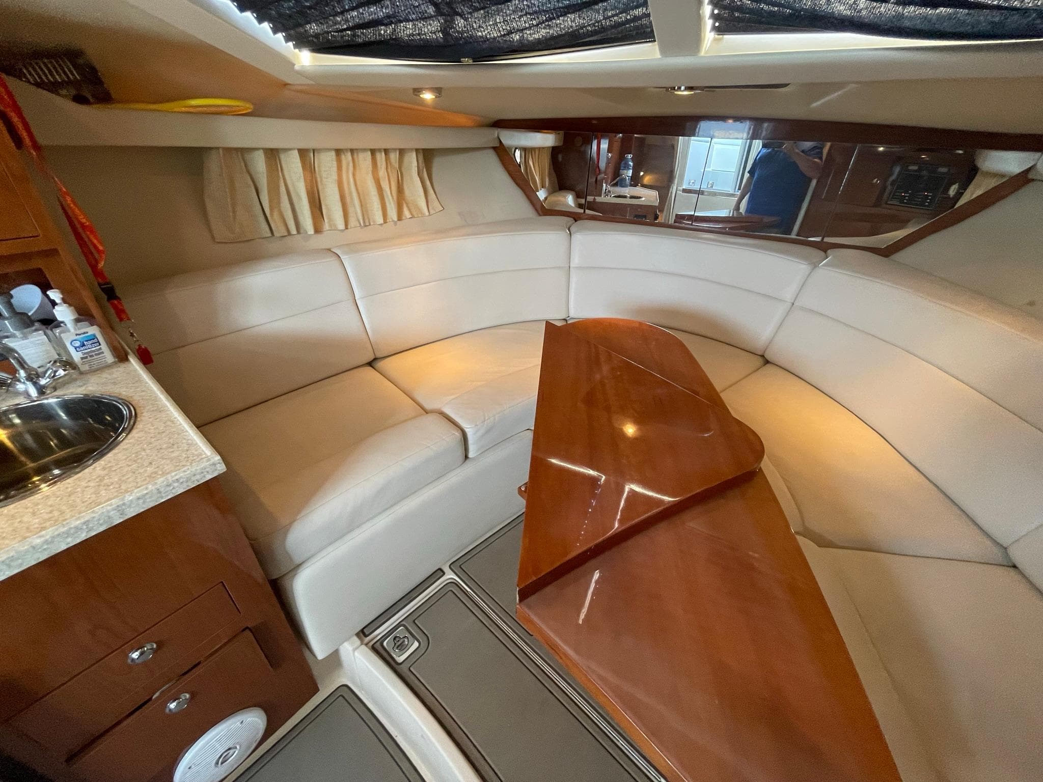 2005 Regal 3060 Window Express interior with curved seating and wooden table.