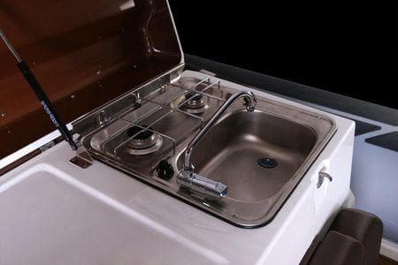 2026 Brig Eagle 10 boat kitchen with dual burners and stainless steel sink.