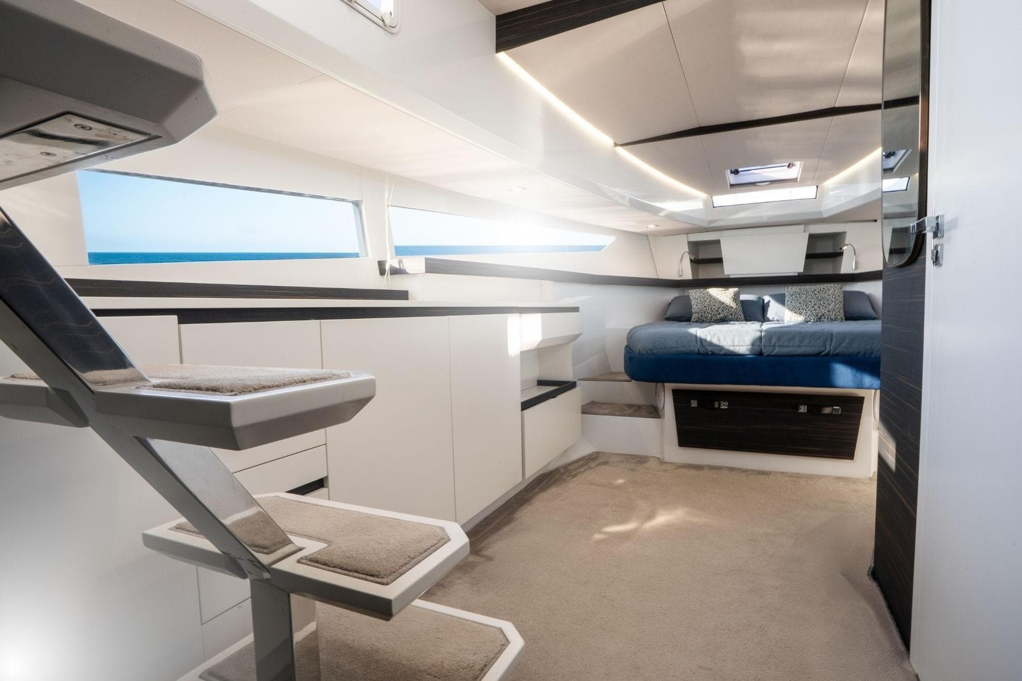 Luxurious interior of 2023 Fiart Seawalker 39 yacht with modern design and comfortable bedding.