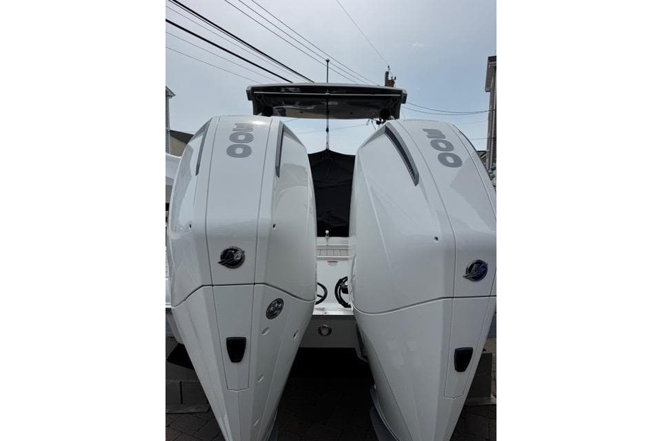 2023 Crownline Eclipse E305 XS boat with dual outboard engines, rear view.