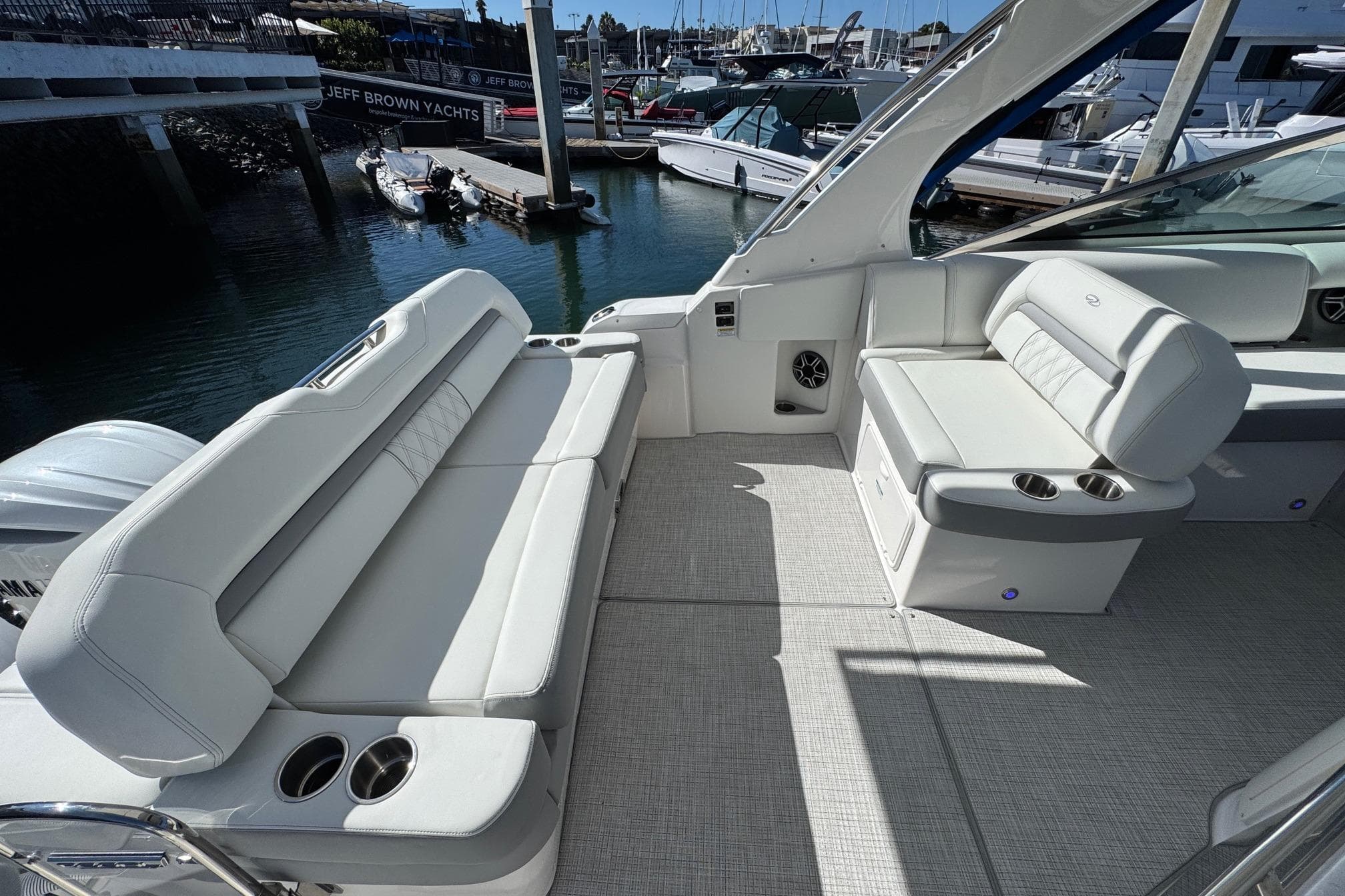 2026 Regal 33 XO yacht interior with luxurious seating and cup holders.