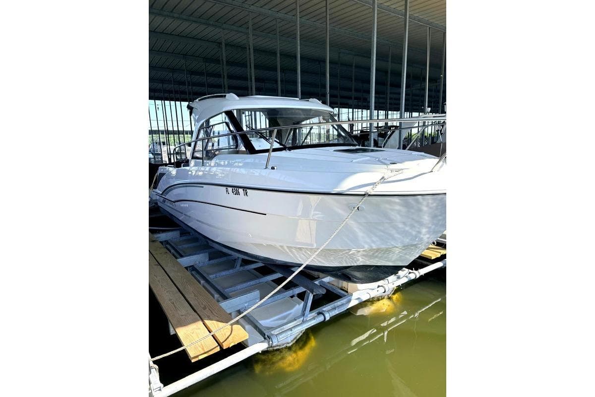 2023 Beneteau Antares 7 boat docked in a marina, showcasing sleek design and modern features.