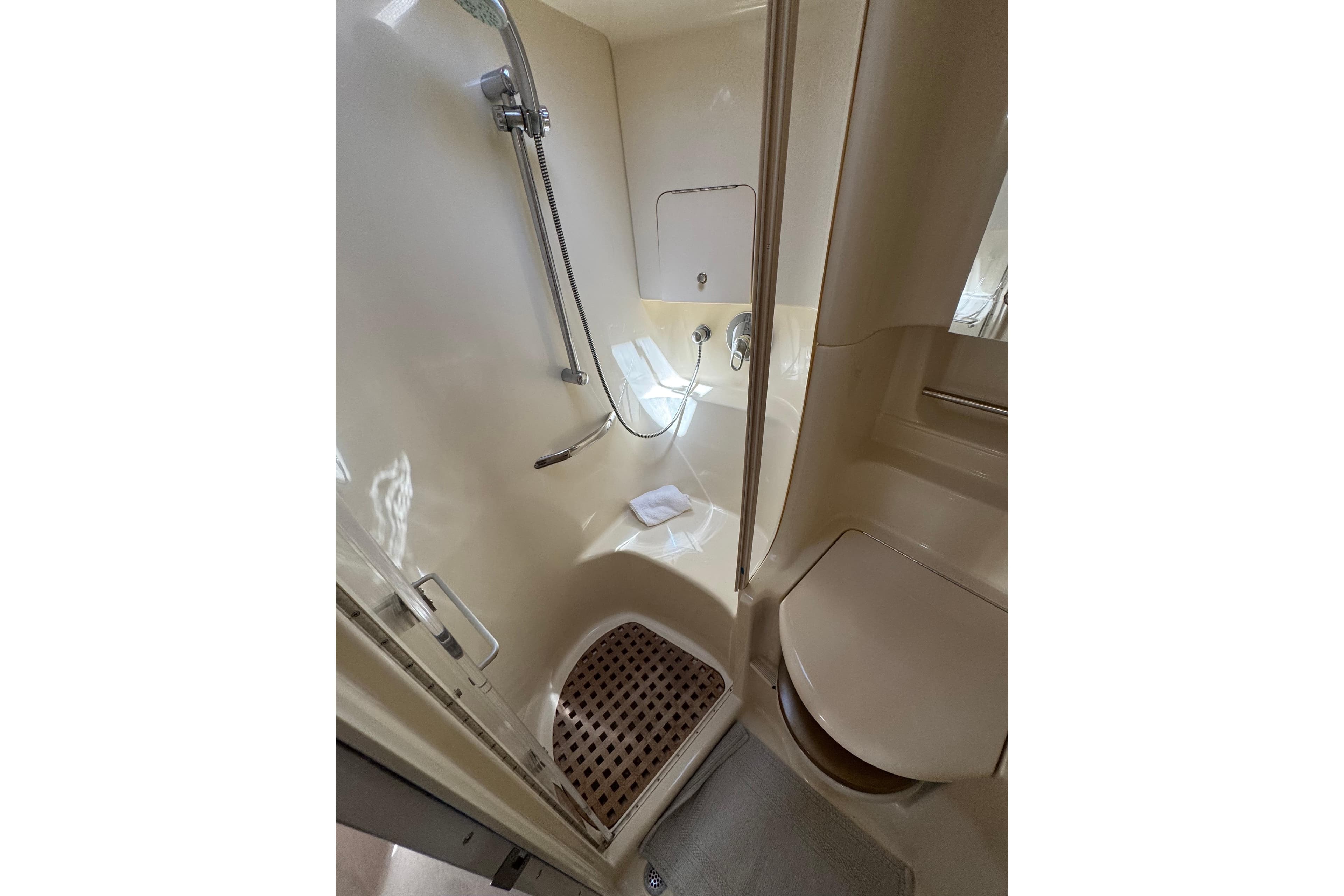 Bathroom interior of 2002 Sea Ray 380 Sundancer yacht, featuring shower and toilet.