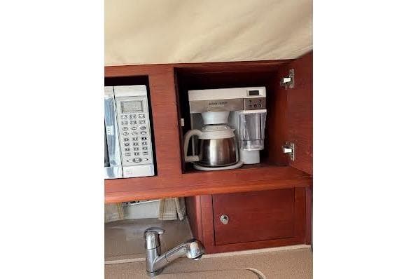 2006 Chris Craft Corsair Heritage kitchen with microwave, coffee maker, and wooden cabinetry.