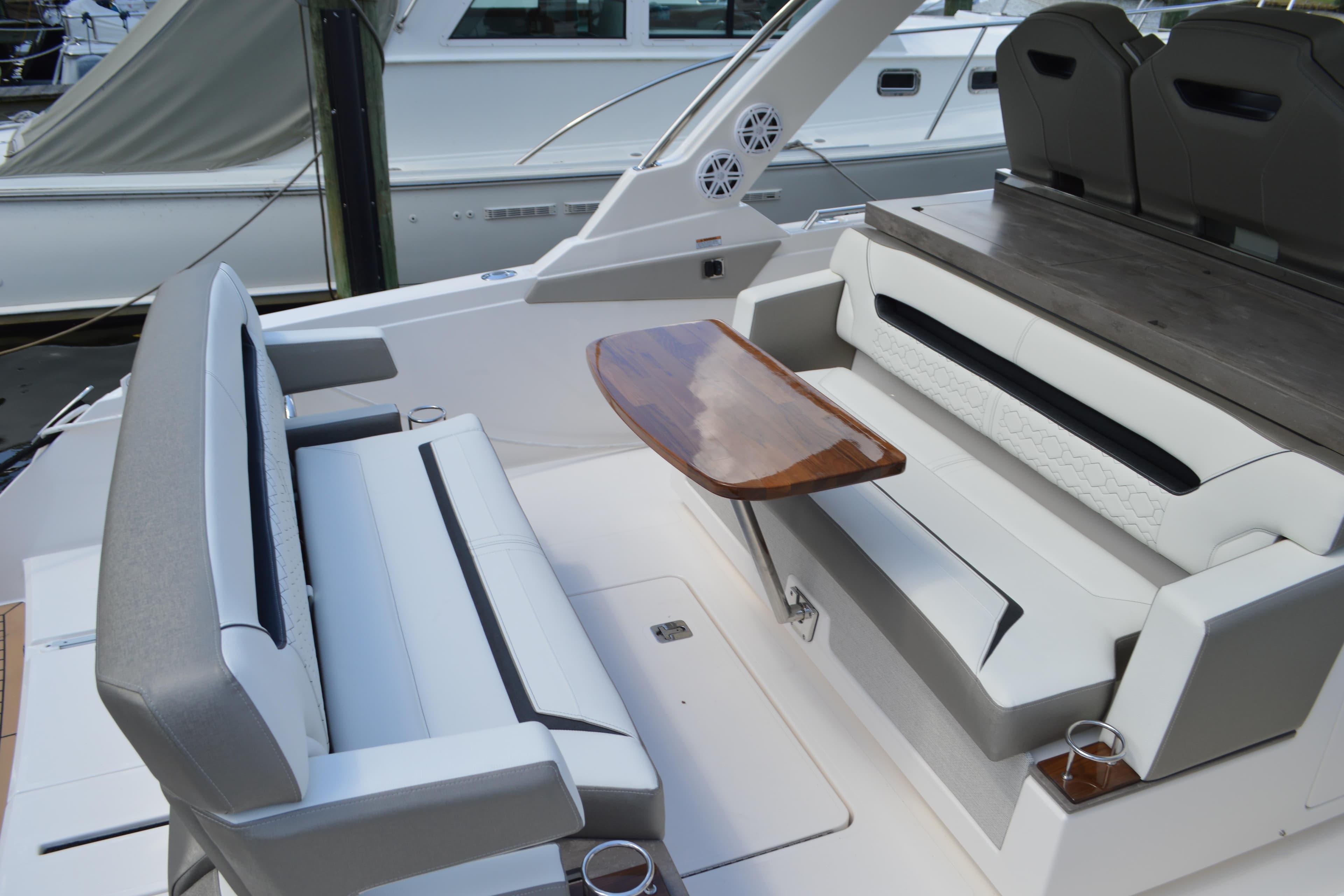 2024 Tiara Yachts 34 LS interior with elegant seating and wooden table.