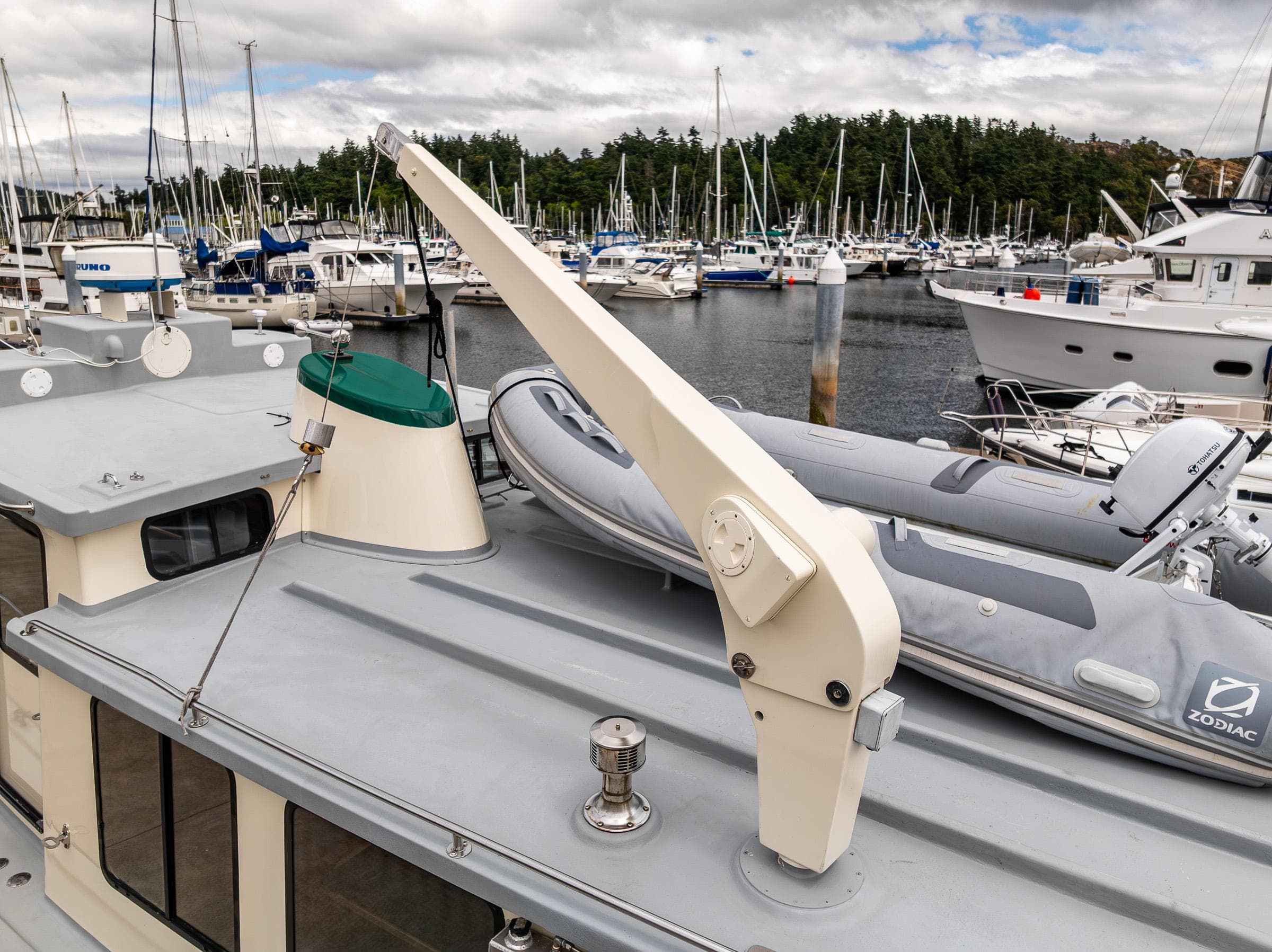 Nordic Tug 37 (2000) with dinghy on deck, docked in a marina.