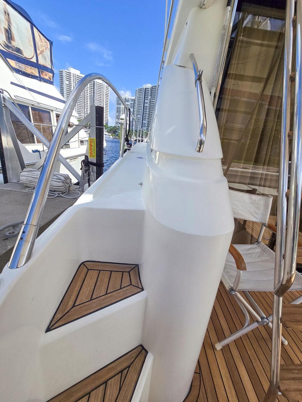 1998 Viking Princess 56 Sport Cruiser with teak deck and modern railing.