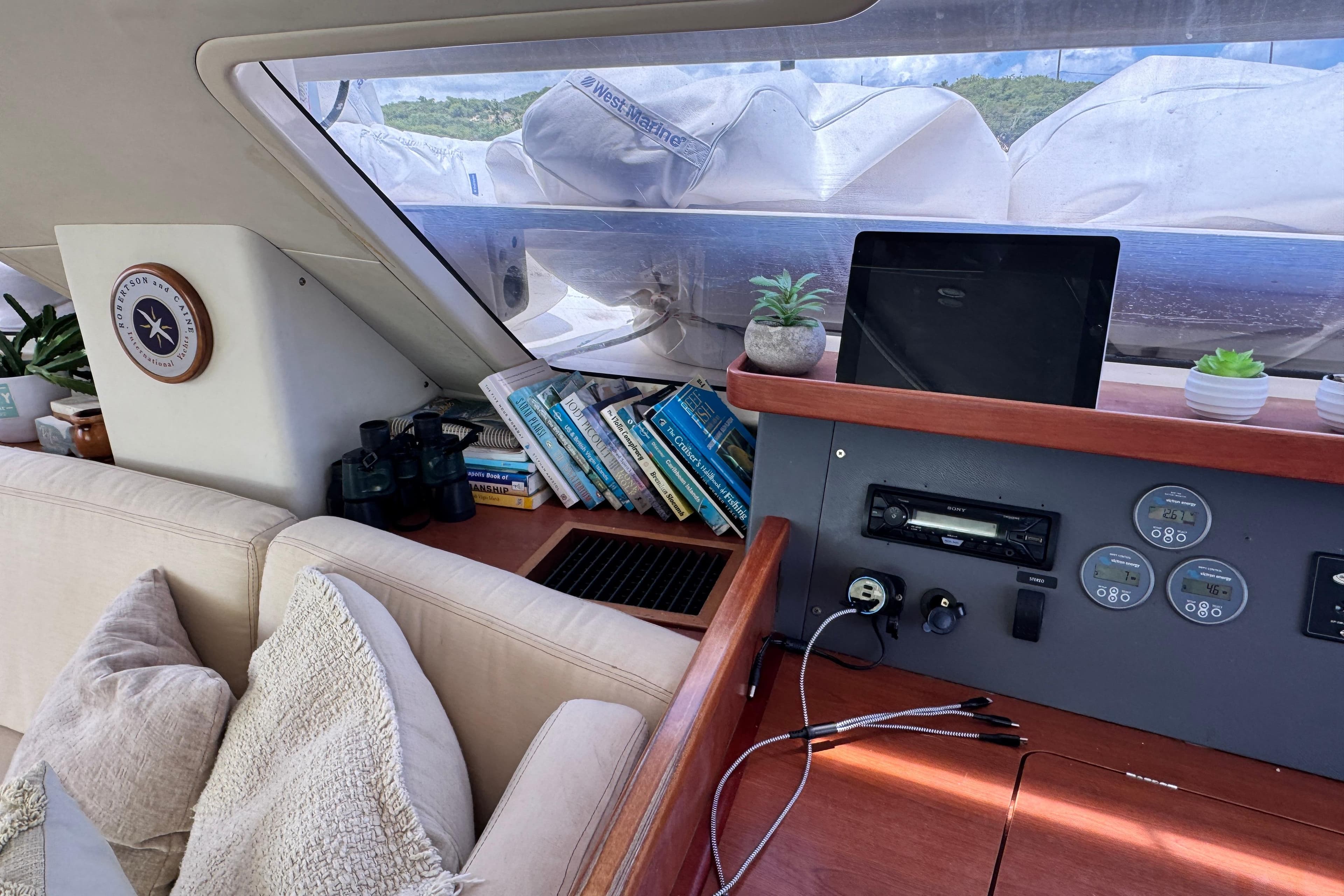 Interior of a 2011 Leopard 46 yacht with books, plants, and navigation equipment.