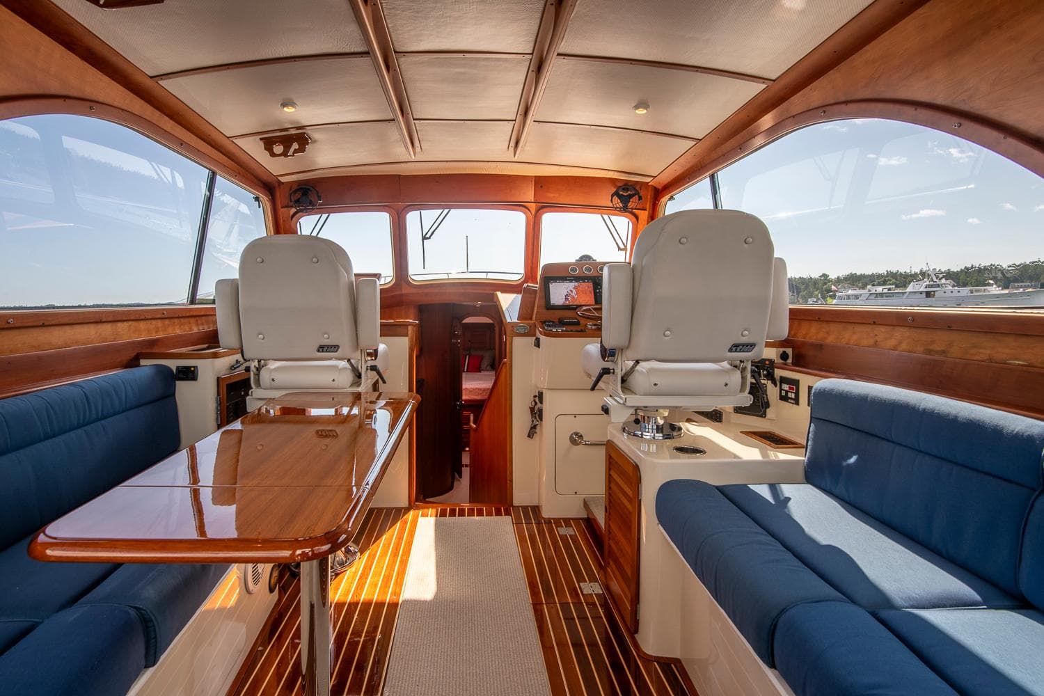 Interior of 2006 Hinckley Talaria 44 FB yacht with elegant seating and wooden finishes.