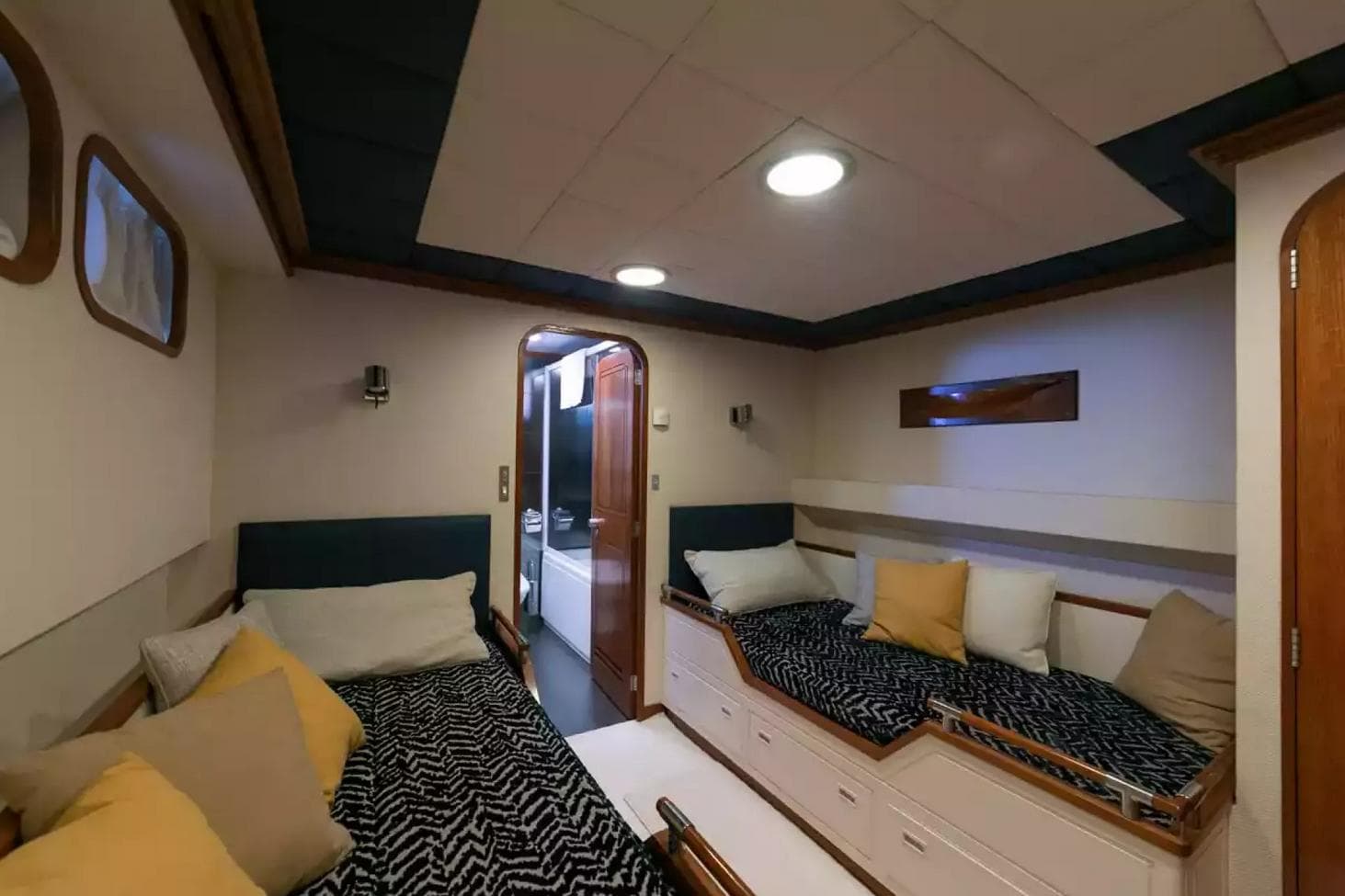 Luxurious cabin interior of 1974 Camper & Nicholsons yacht with cozy beds and elegant decor.