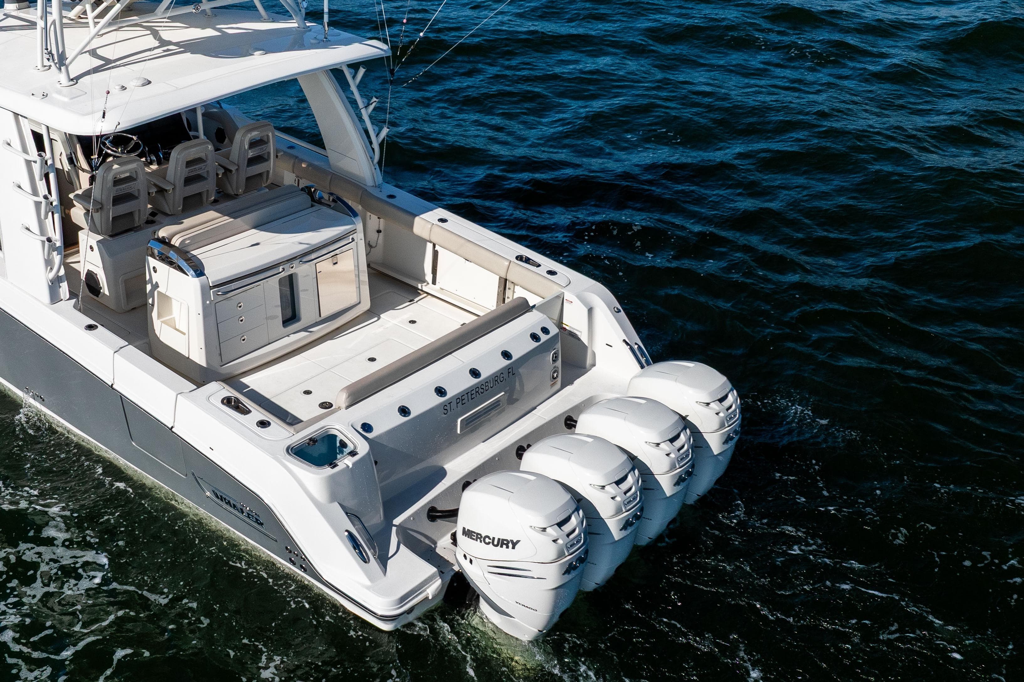 2021 Boston Whaler 420 Outrage with triple Mercury engines cruising on open water.