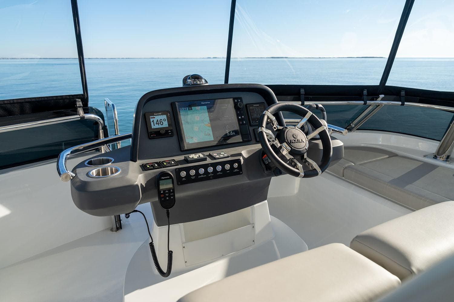 Manufacturer Provided Image: Helm of 2026 Aquila 42 Yacht with navigation system and steering wheel.