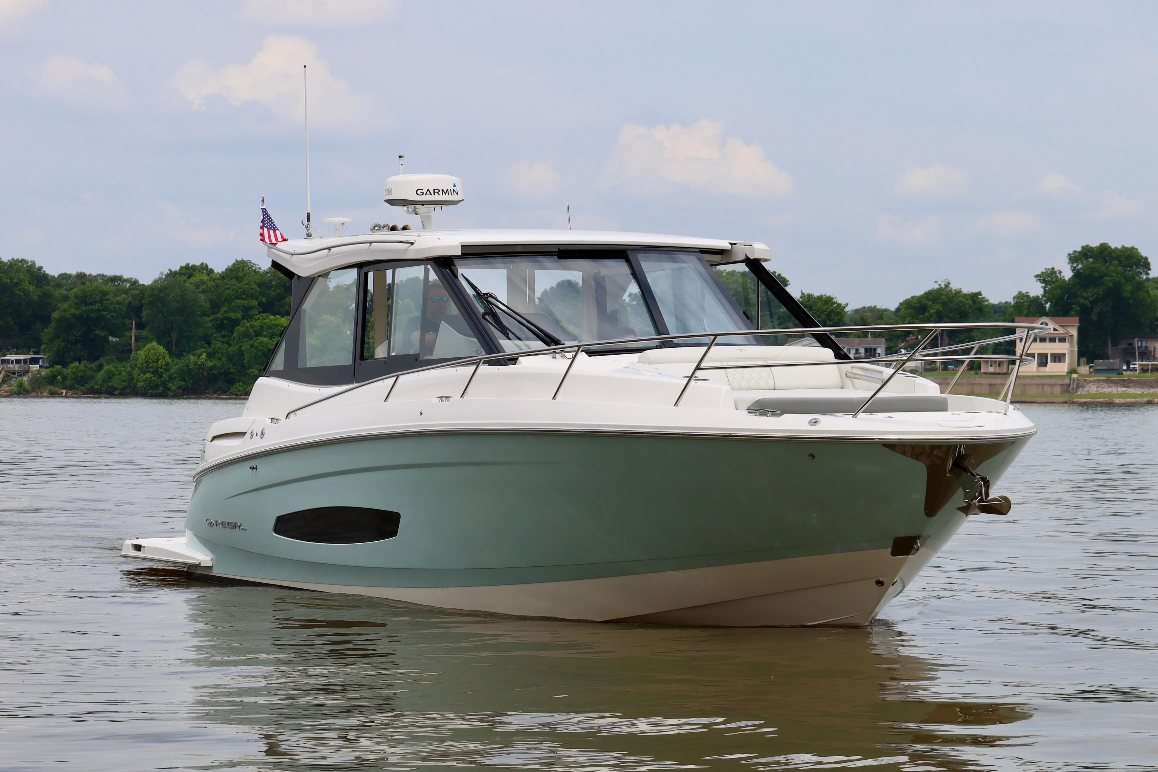 2022 Regal 36 Grande Coupe boat on calm water, showcasing sleek design and modern features.