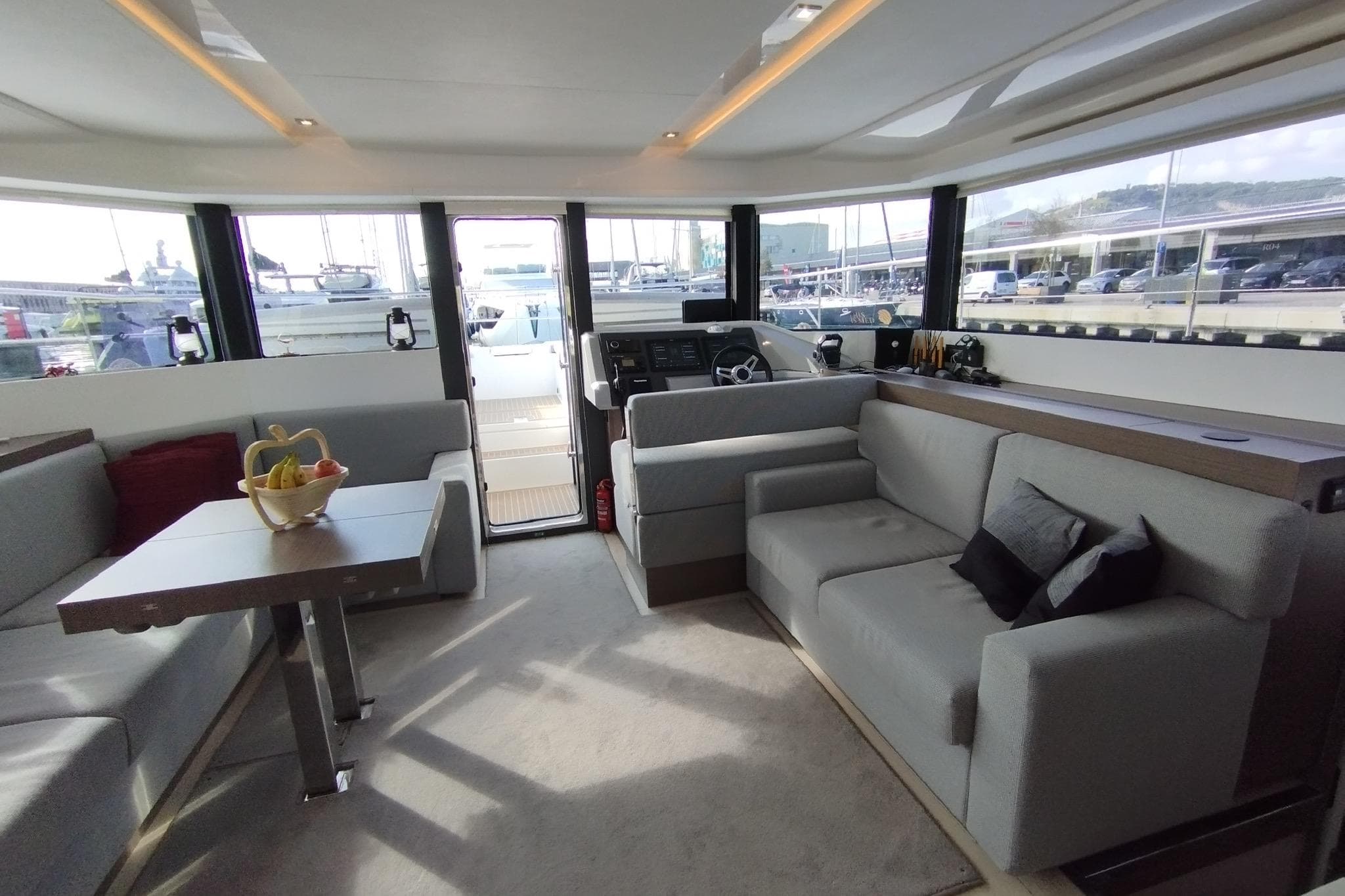Luxurious interior of 2024 Leopard 53 Powercat yacht with modern seating and panoramic windows.